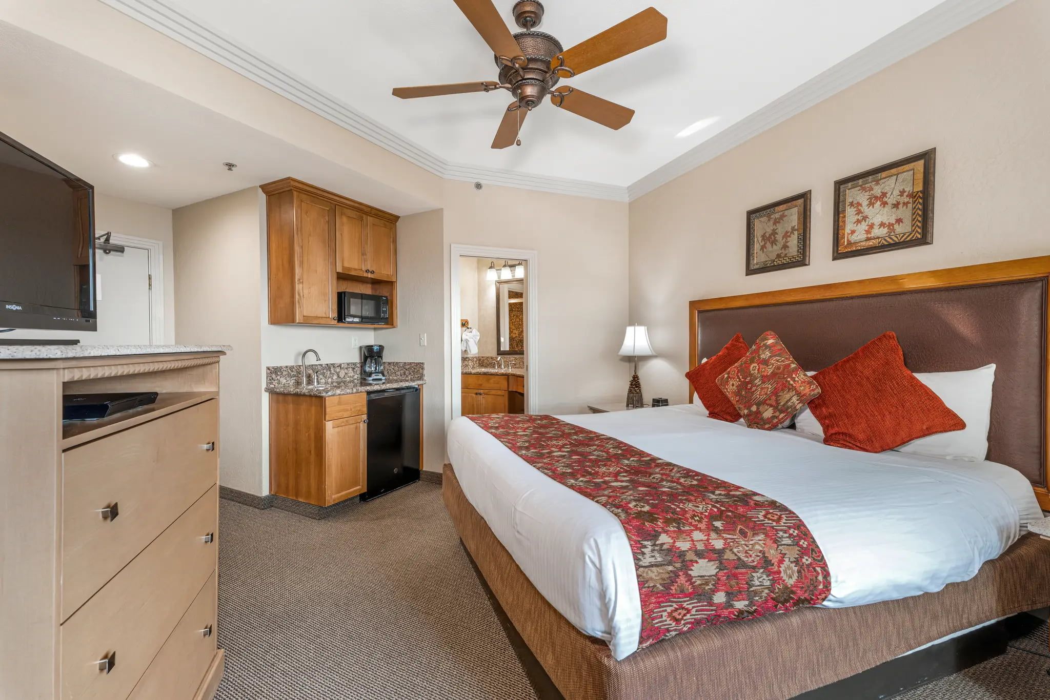 image Spacious studio suite featuring a plush king bed, cozy seating area, and convenient kitchenette.
