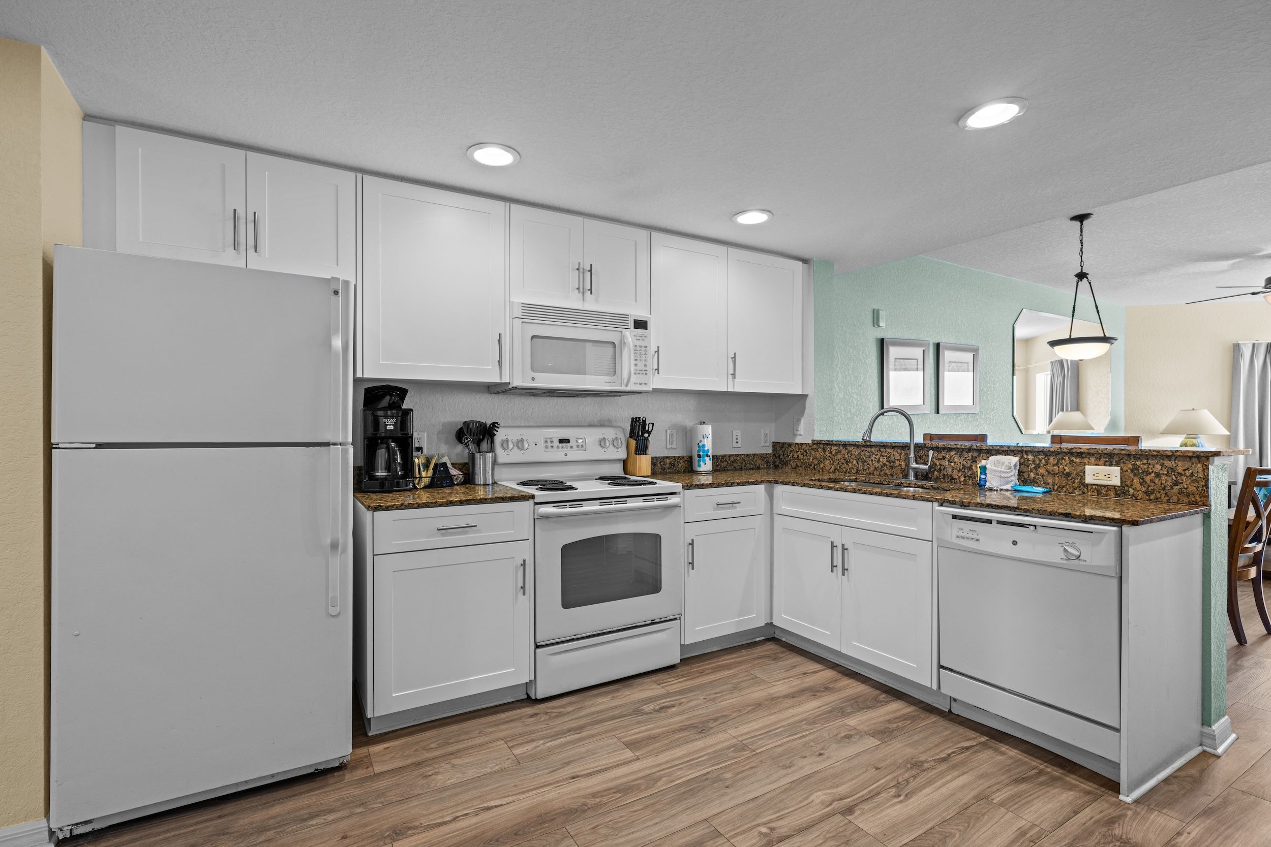 image Cook with ease in this well-equipped kitchen, featuring sleek cabinets and modern appliances.