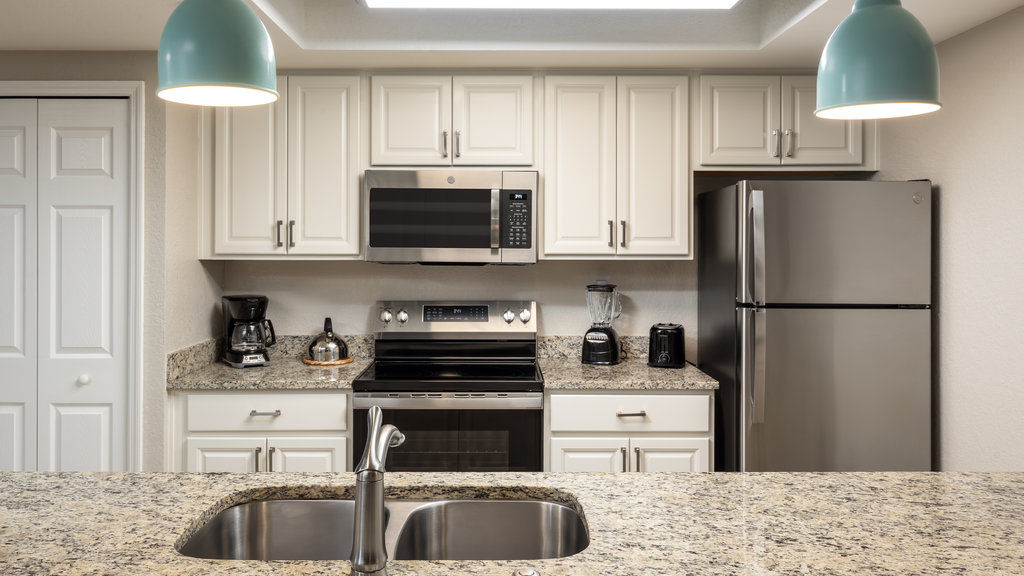 image Cook up delicious meals in this bright, fully-equipped kitchen with granite countertops and modern appliances.