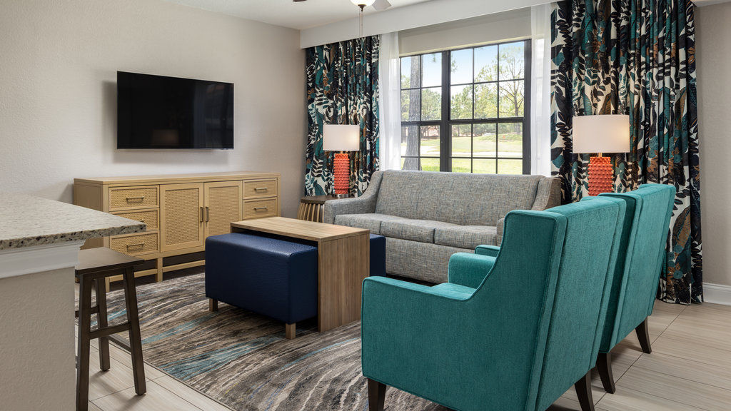 image Relax in this stylish living area, complete with cozy seating and vibrant decor, perfect for unwinding after a day of adventure.