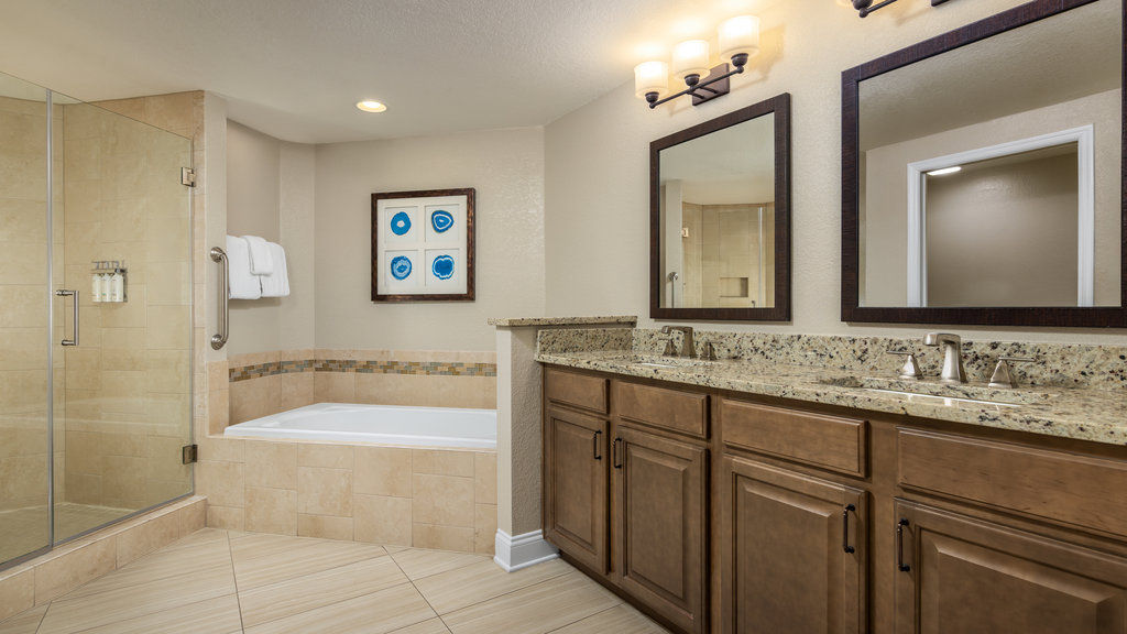 image Relax in a beautifully appointed bathroom featuring a soaking tub and elegant tile accents.