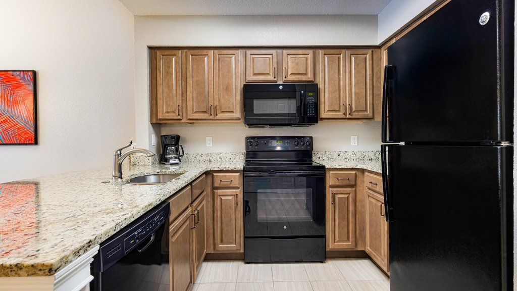 image Cook gourmet meals in this stylish, fully-equipped kitchen featuring modern appliances and beautiful granite countertops.