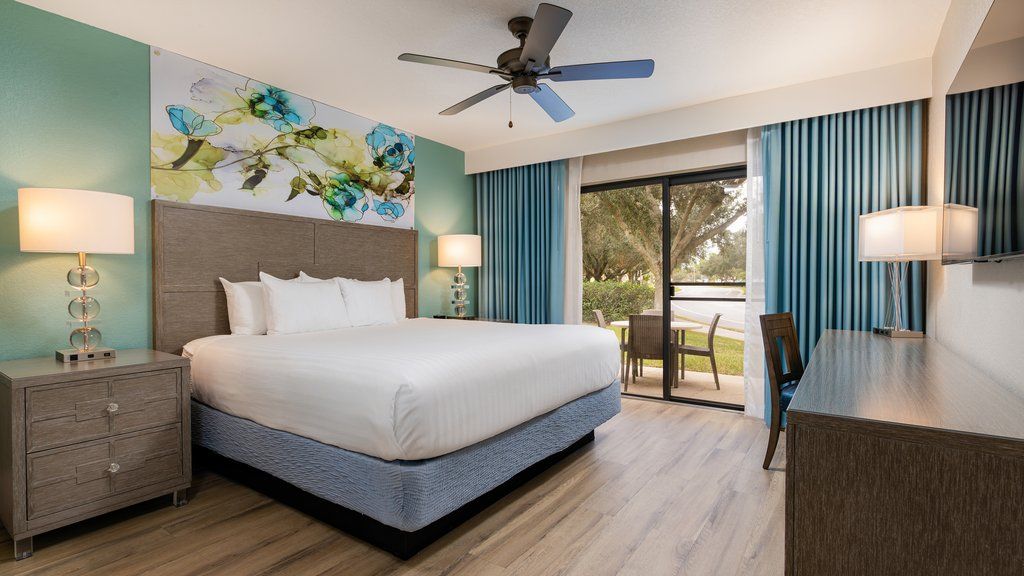 image Unwind in a cozy bedroom featuring a plush king-size bed and a private patio to enjoy morning coffee.