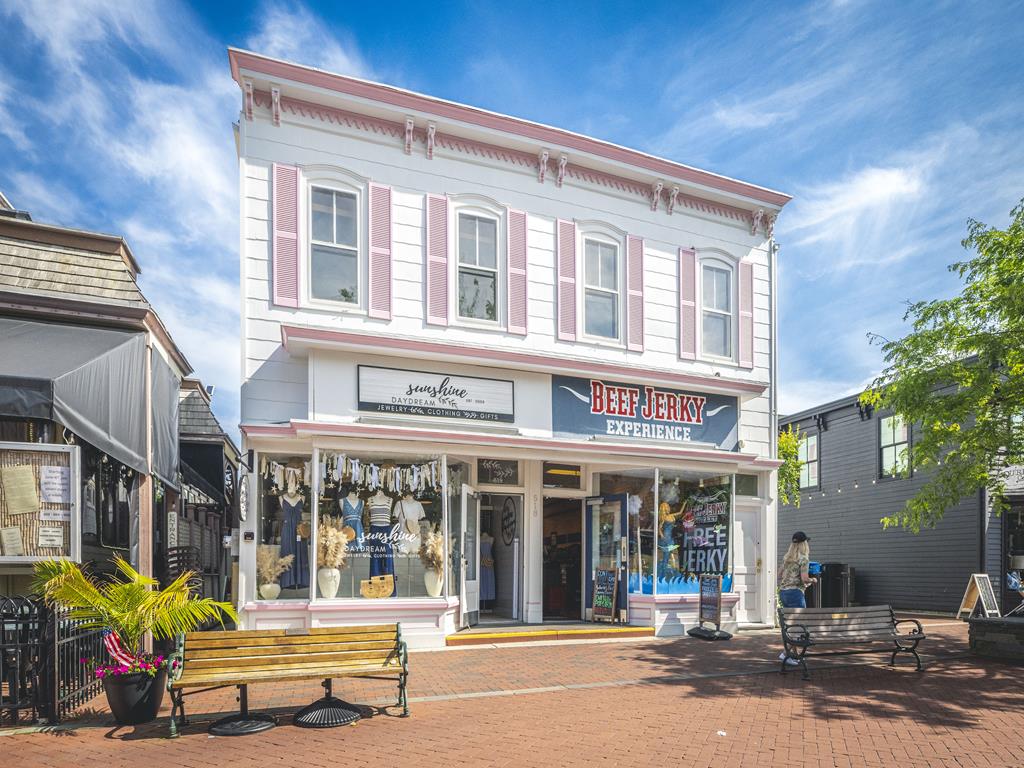 image Discover delightful local shops just steps away, offering unique clothing and gifts in a vibrant outdoor setting.