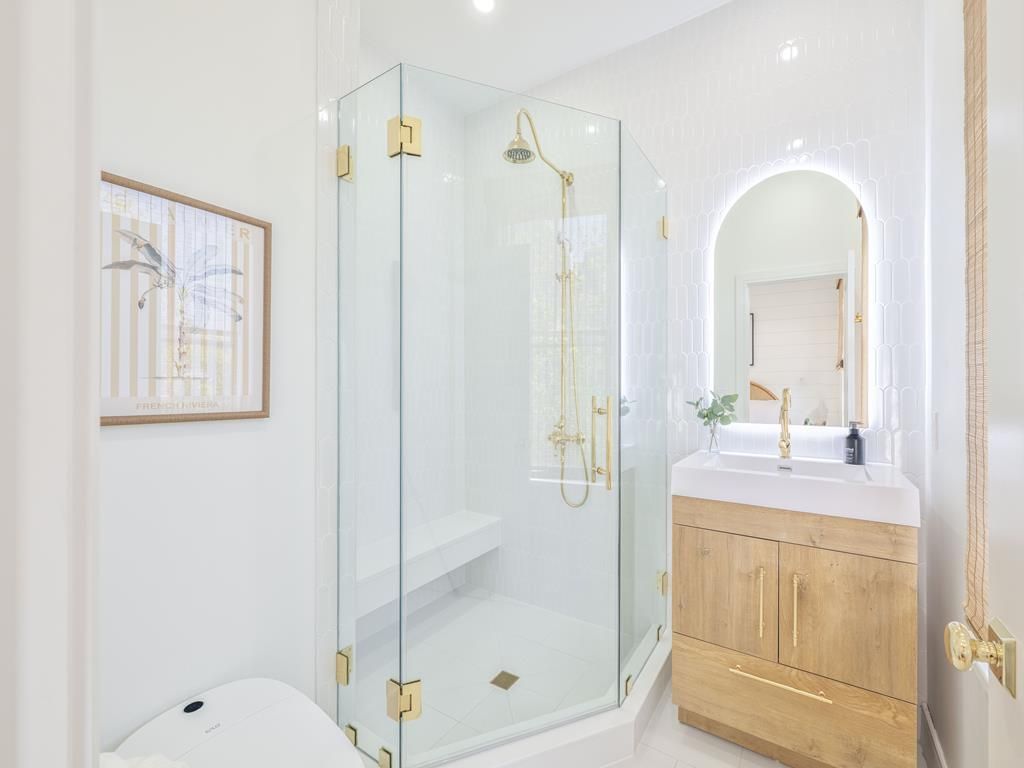 image Upscale bathroom featuring a sleek glass shower and modern vanity, providing a rejuvenating escape.