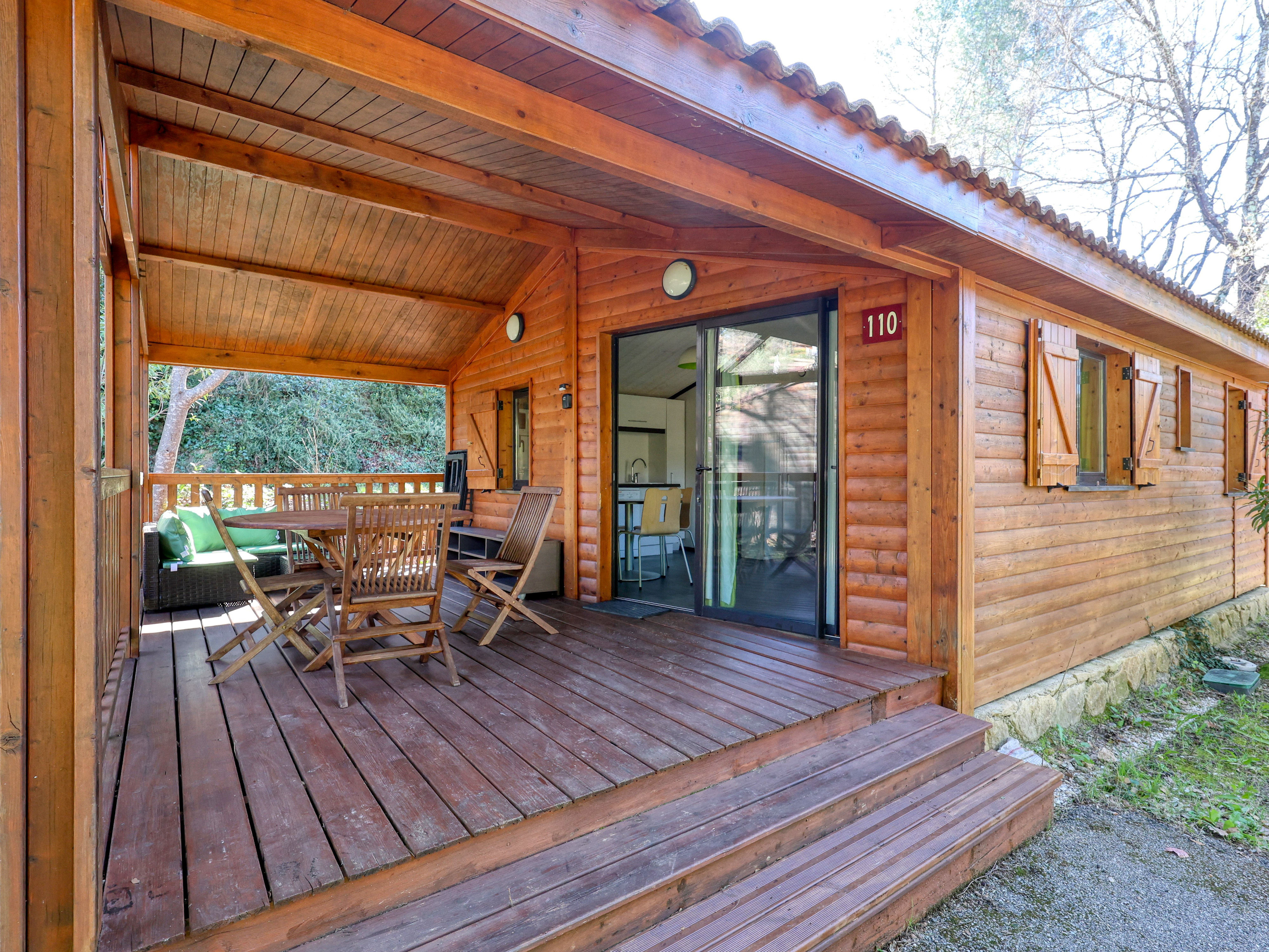 image Step into this charming wooden chalet, blending comfort with the tranquility of nature.