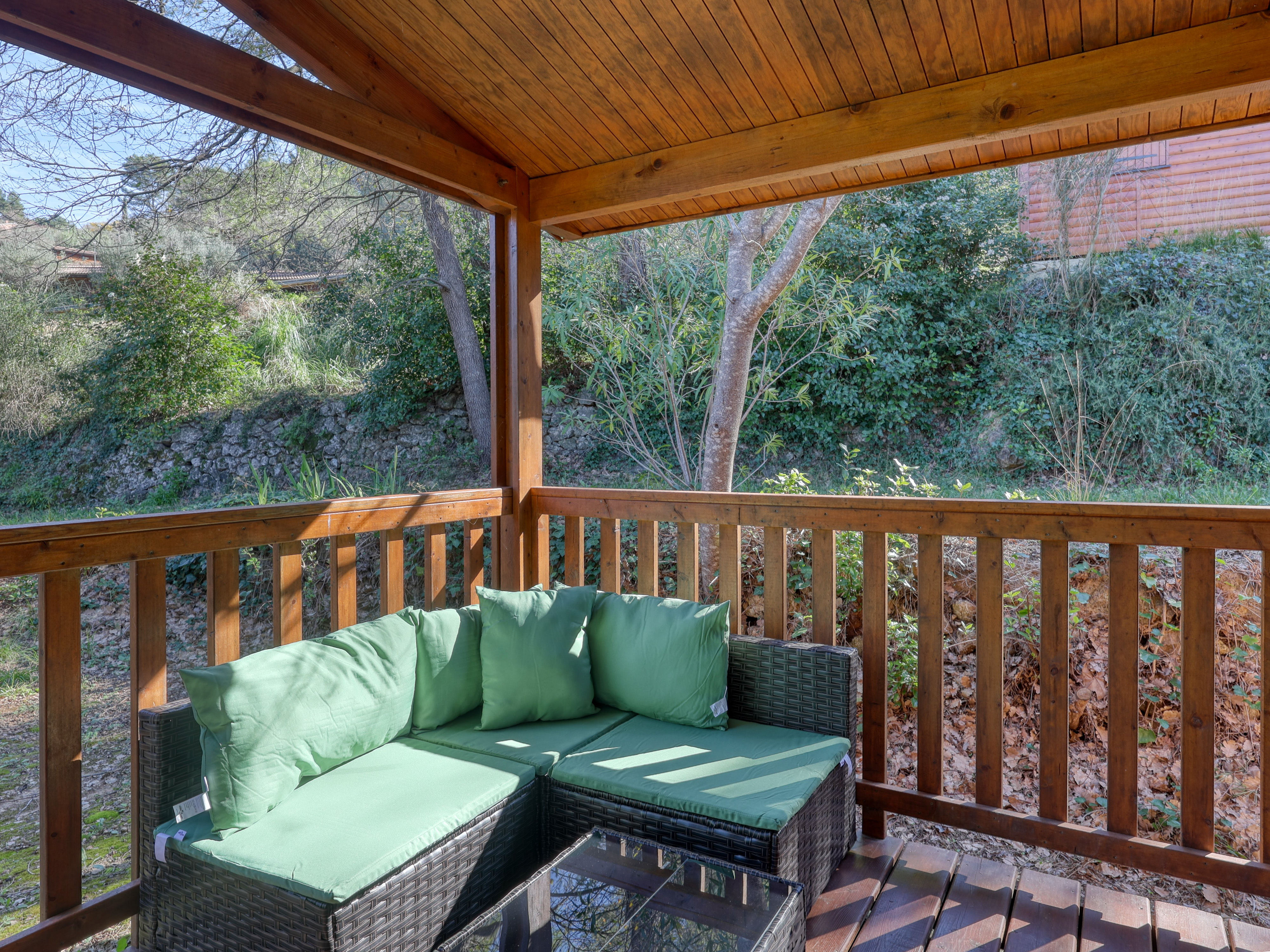 image Relax on your private terrace, perfect for unwinding amidst lush greenery and cozy seating.
