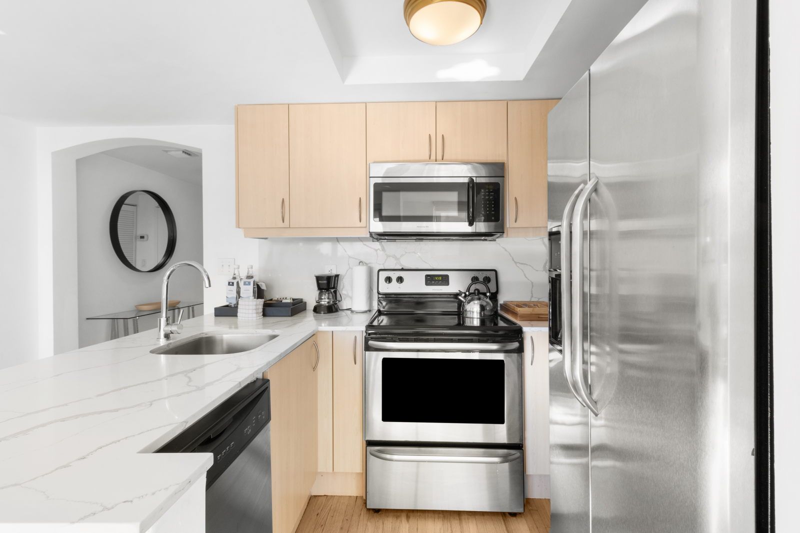 image Cook up culinary delights in this sleek, fully-equipped kitchen featuring modern appliances and a spacious counter.