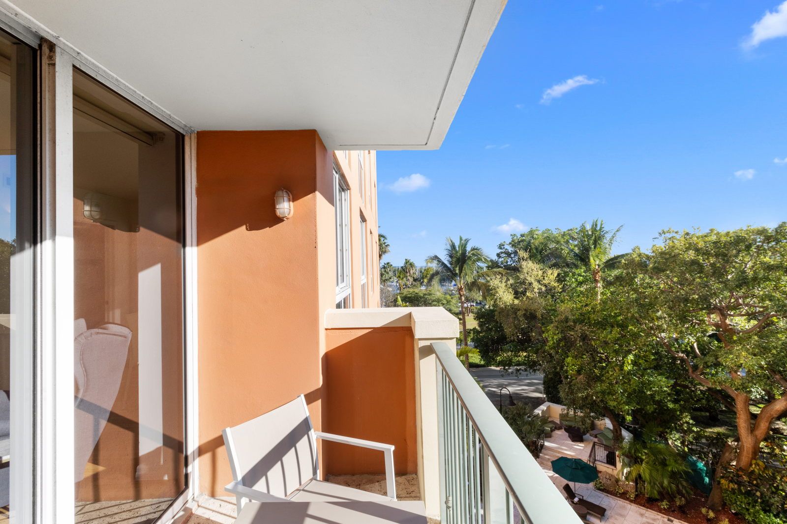 image Step onto your balcony and embrace the tranquility, surrounded by swaying palms and vibrant foliage.