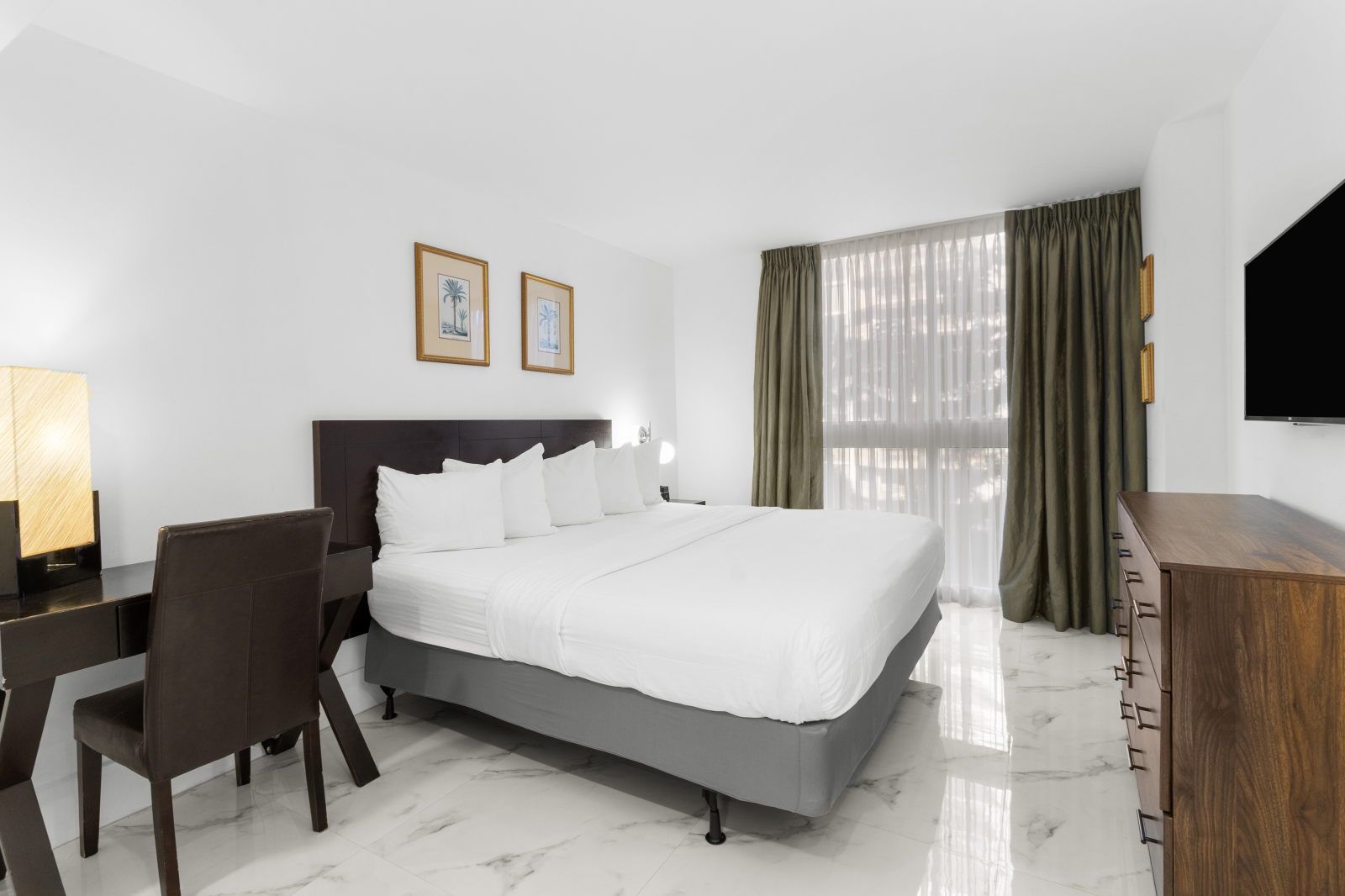 image Unwind in a bright space featuring a plush bed and elegant decor, perfect for relaxing after a day of exploration.
