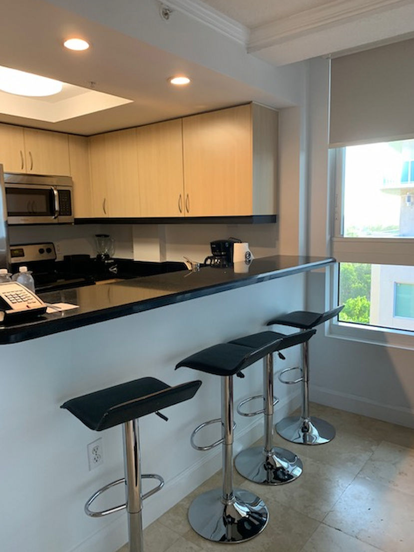 image Cook up your favorite meals in a modern kitchen equipped with sleek appliances and bar seating for casual dining.