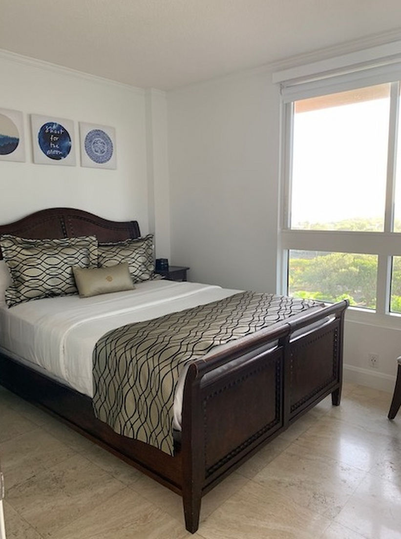 image Enjoy restful nights in this elegantly decorated bedroom with tasteful artwork and lovely natural light.