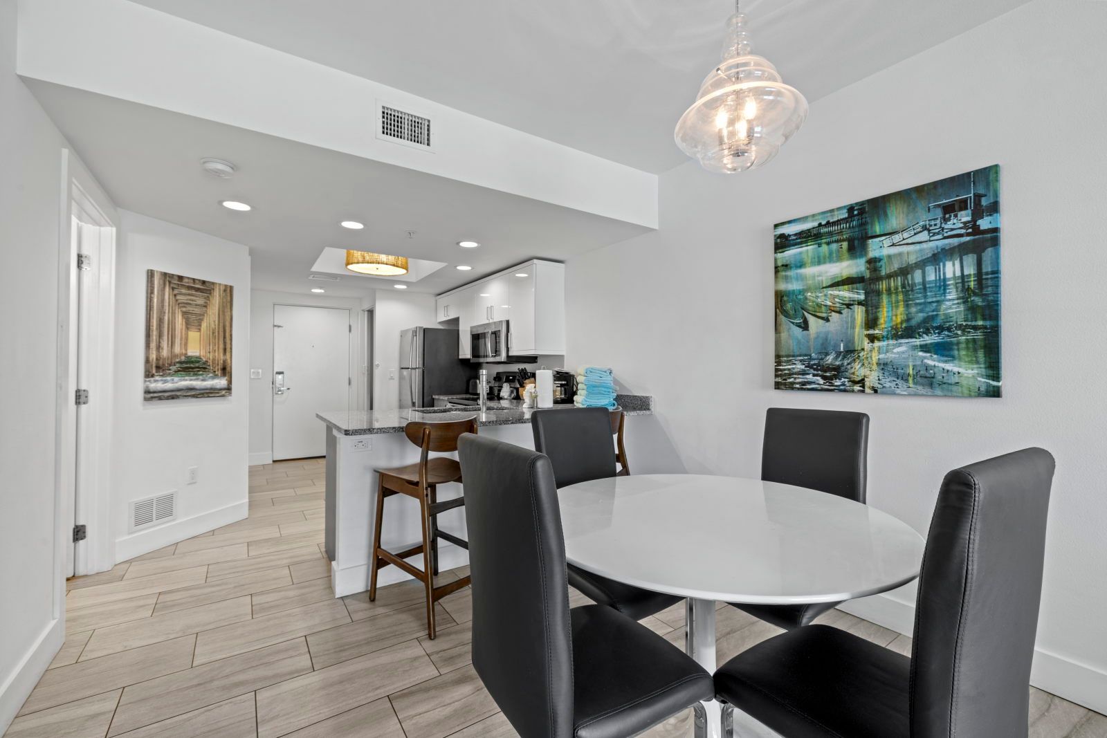 image Gather around the modern dining table, just steps away from your fully equipped kitchen.