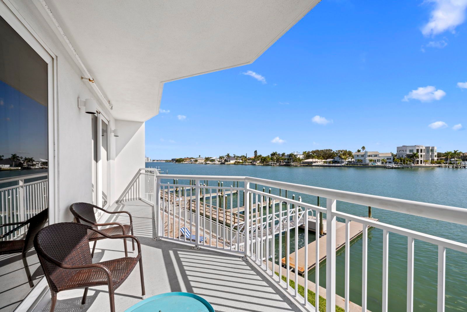 image Bask in the sunlight on your spacious balcony, complete with comfortable seating and picturesque waterfront views.