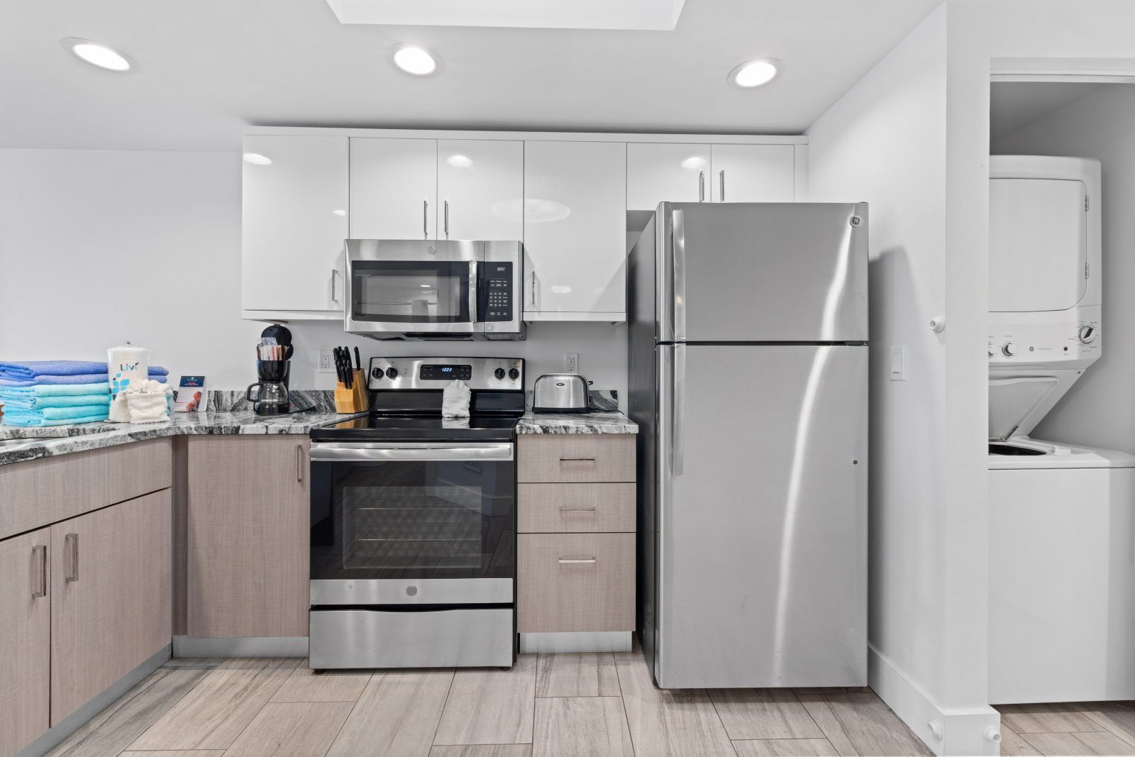 image Whip up your favorite meals in this modern kitchen, complete with stainless appliances and a convenient washer/dryer.