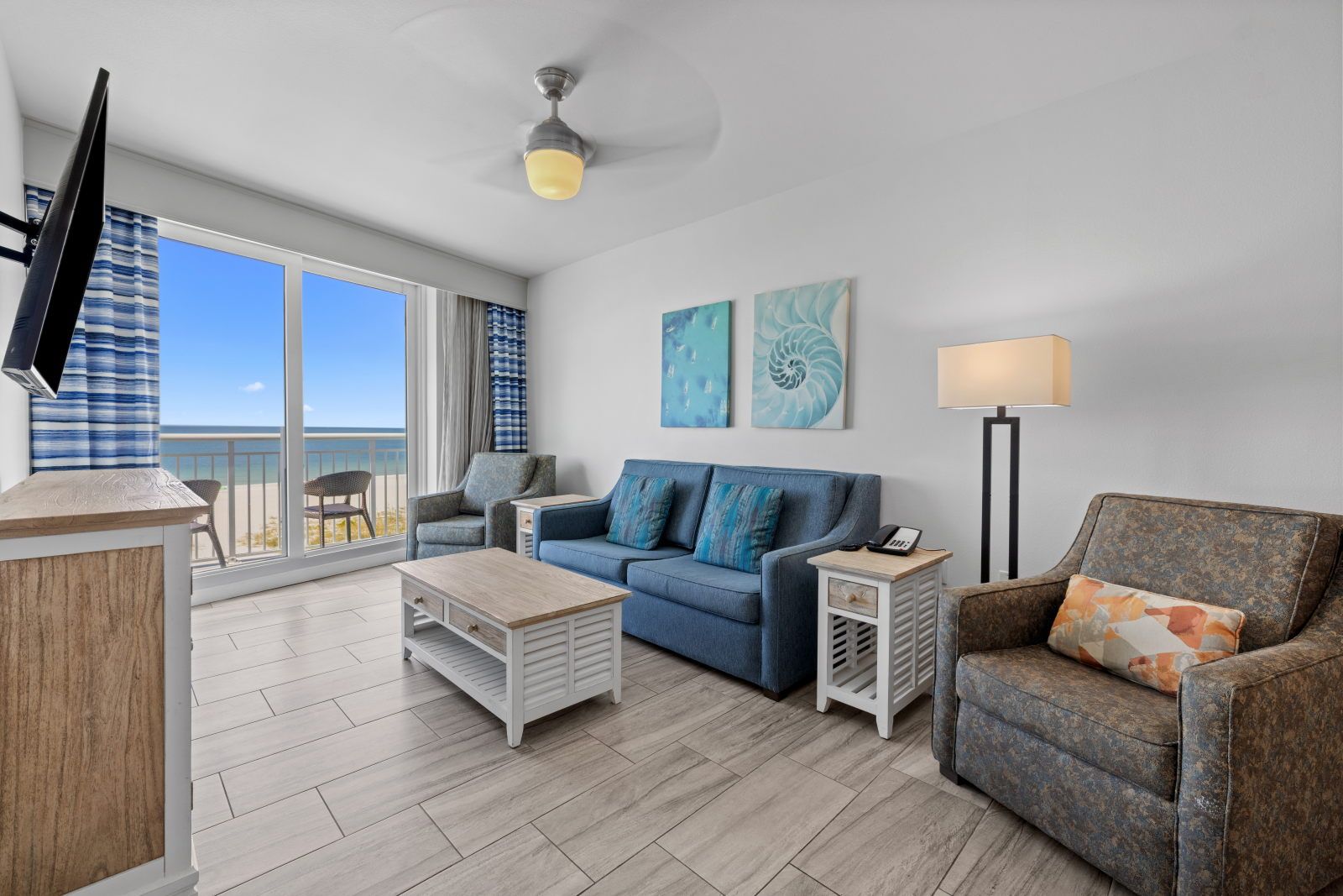 image Kick back in the cozy living room, where the sea breeze flows in and views of the beach beckon from your window.