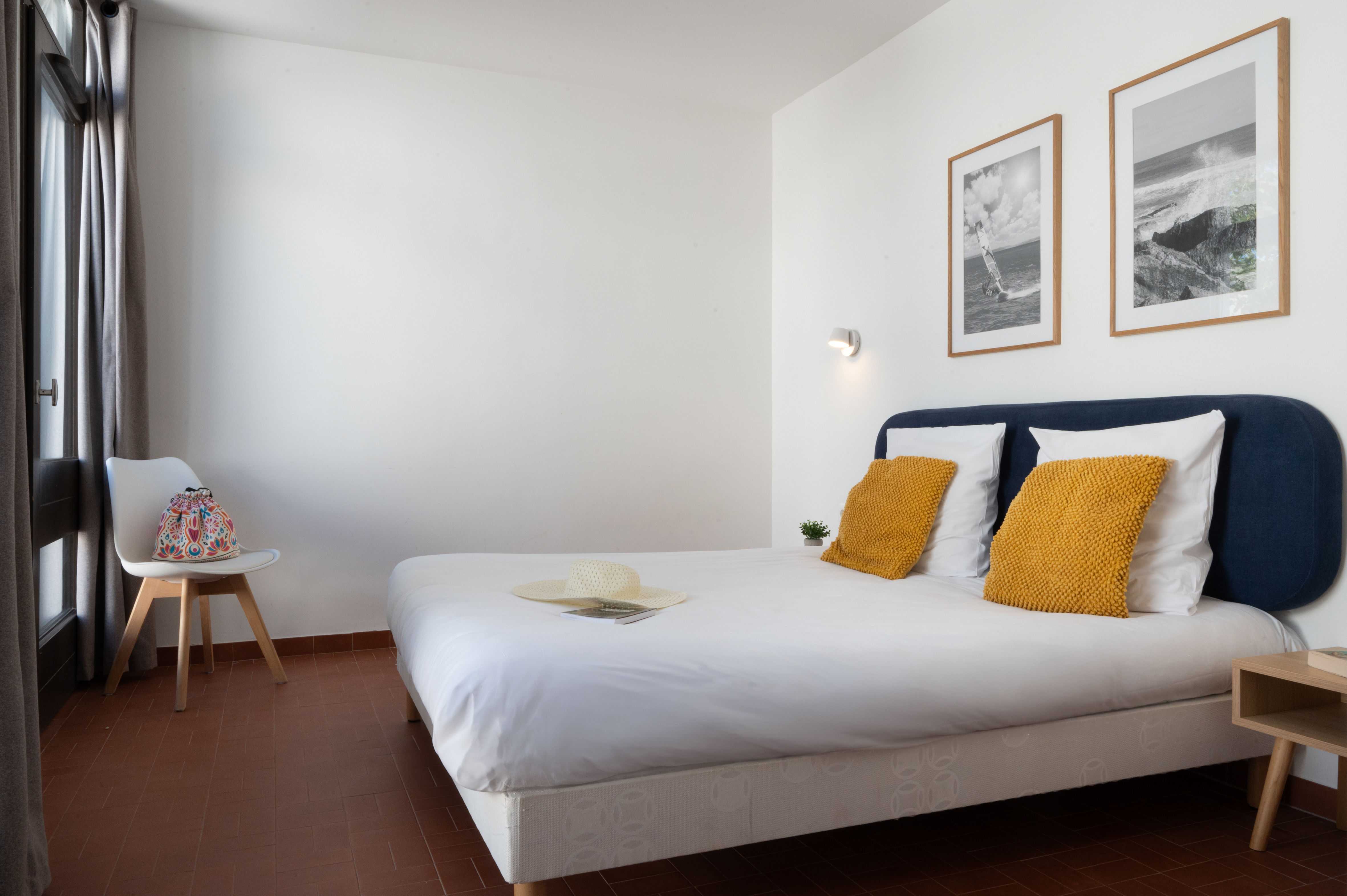 image The double bedroom with yellow accents — a restful retreat after a day on the Mediterranean beach.
