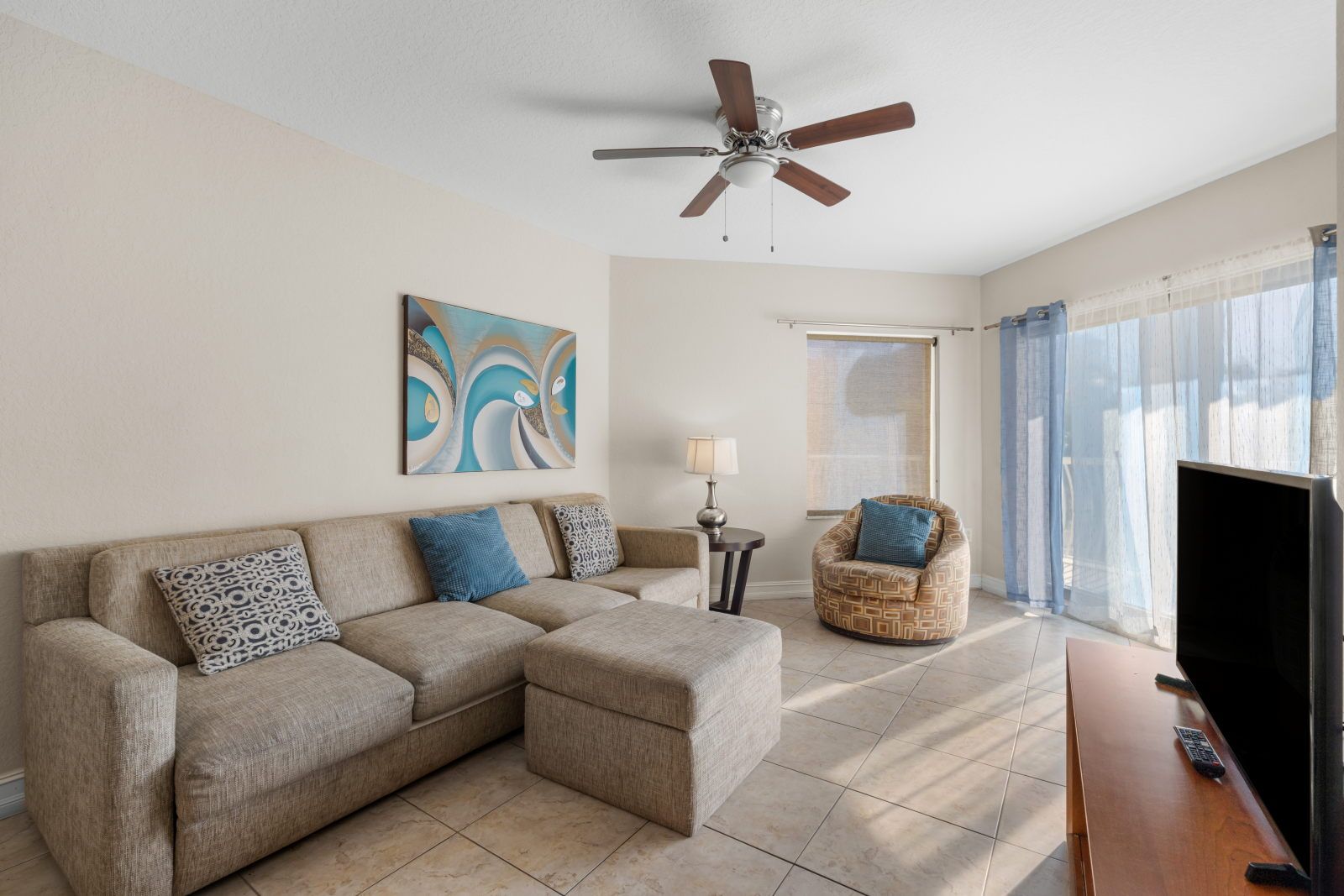 image Relax in this stylish living space, complete with cozy seating and a calming color palette.