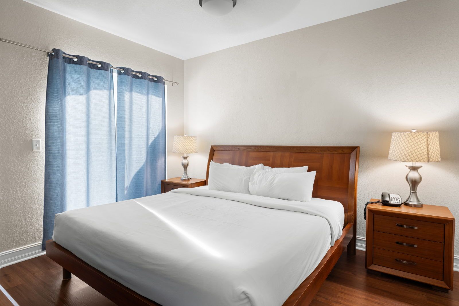 image Rest easy in this cozy bedroom, featuring soft lighting and a comfortable king bed.