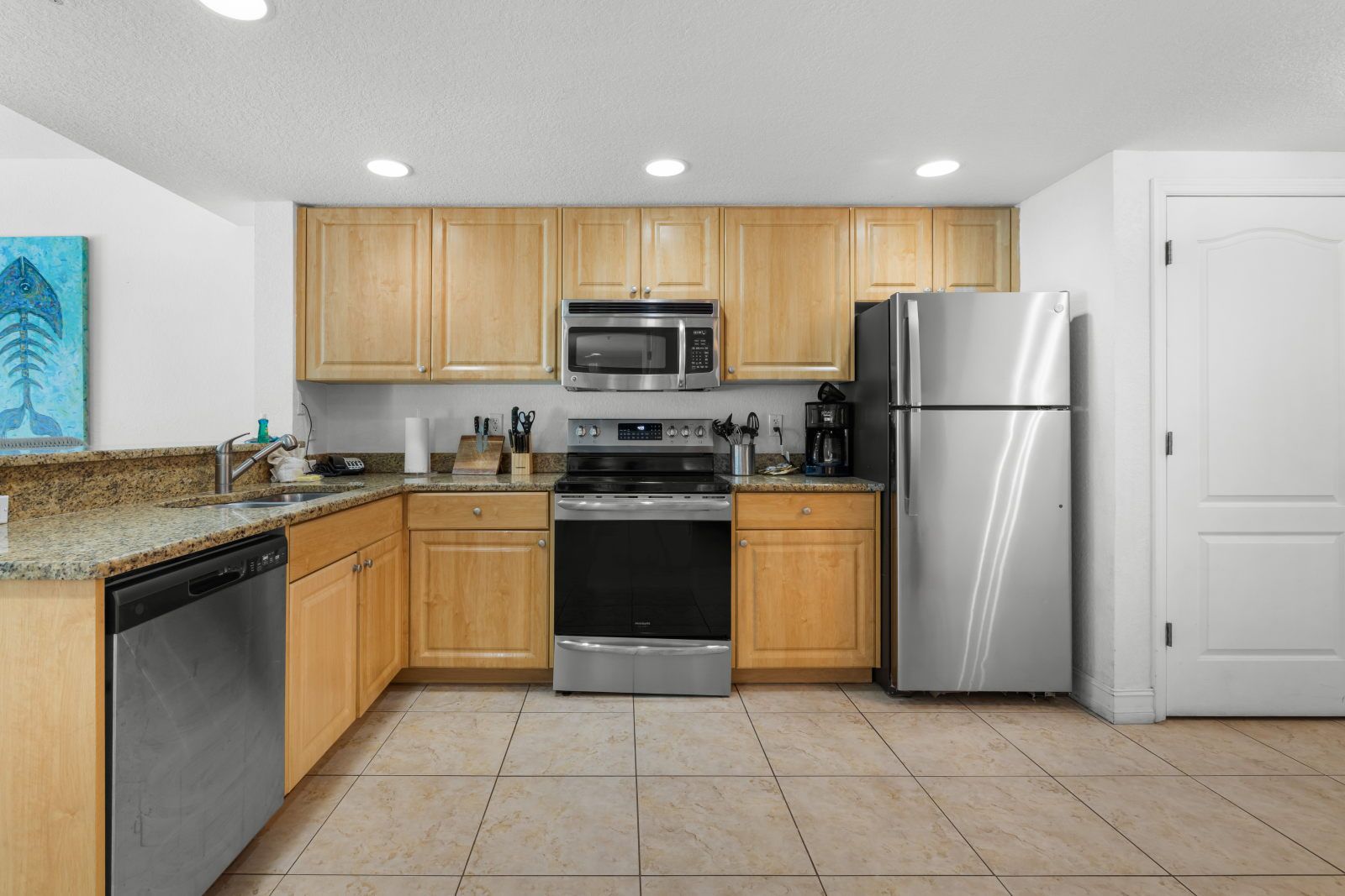 image Cook gourmet meals in a spacious kitchen with granite countertops and modern stainless steel appliances.