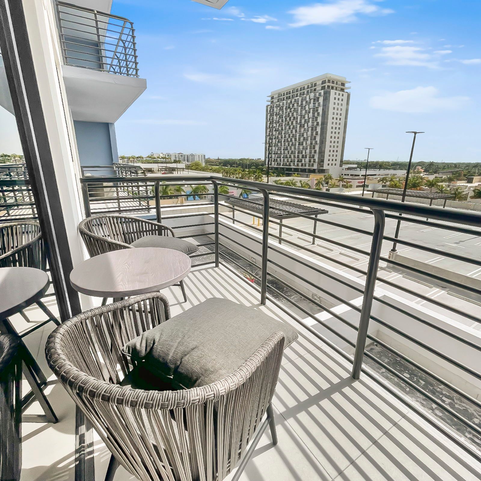 image Step onto your private balcony with sleek seating, perfect for morning coffee.