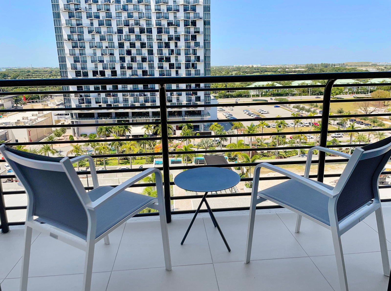 image Sip your morning coffee on the balcony, enjoying partial views and fresh air in a relaxing setting.