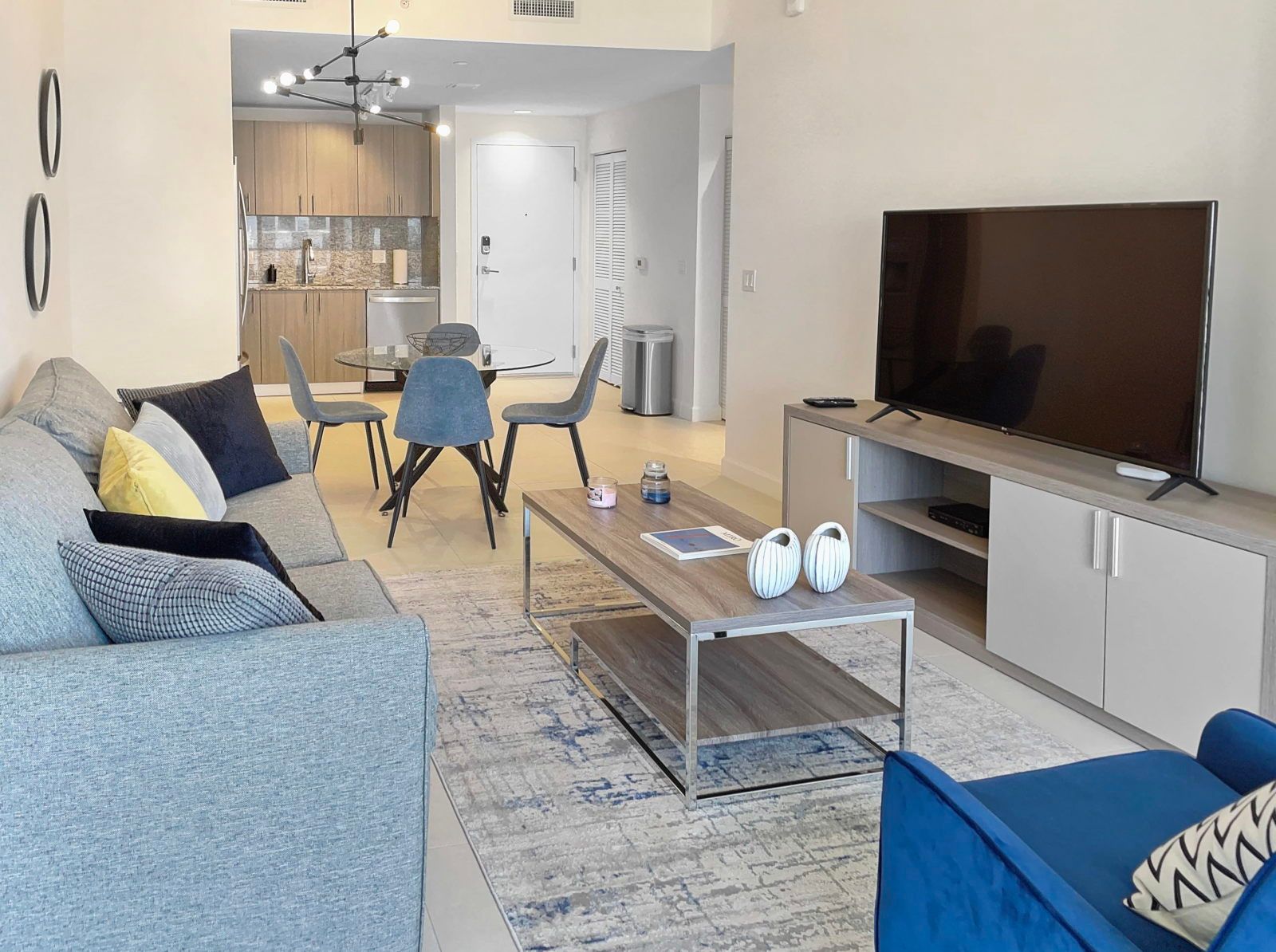 image Savor your favorite shows in this inviting living room, complete with plush seating and a large Smart TV.