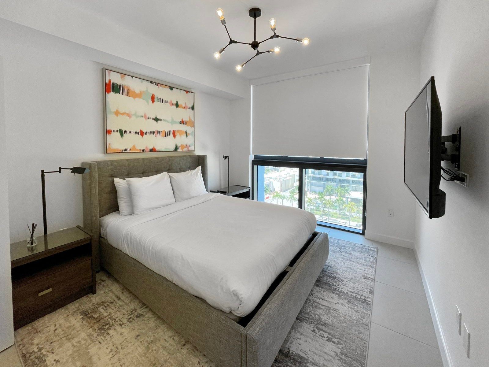 image Retreat to this serene bedroom, designed for comfort with a plush king bed and stylish decor.