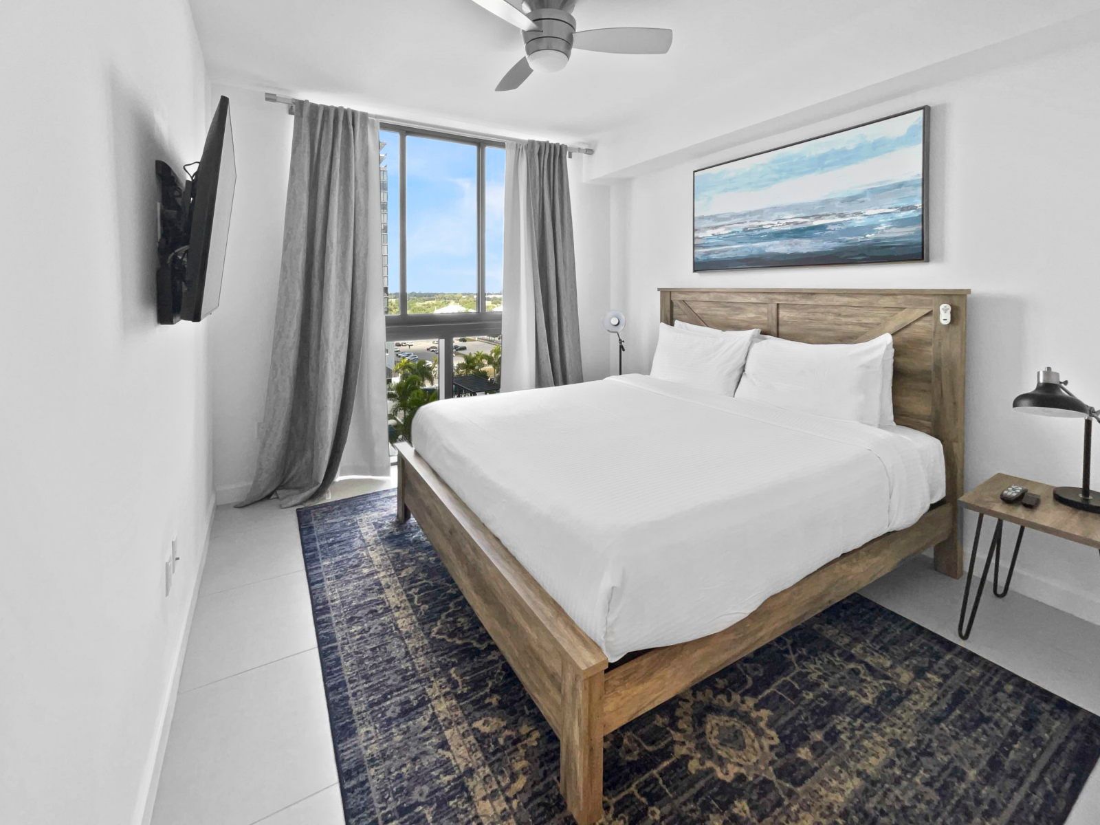 image Wake up in a plush king bed, surrounded by modern decor and bright natural light.