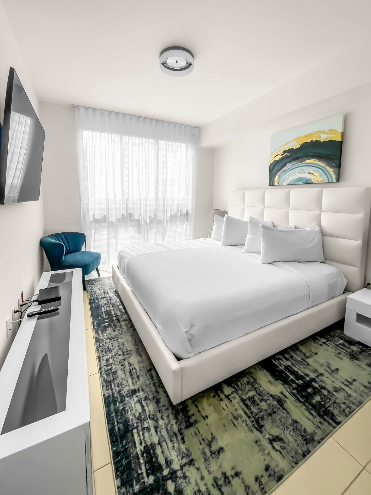 image Relax in the plush king bed, surrounded by chic decor and abundant natural light.