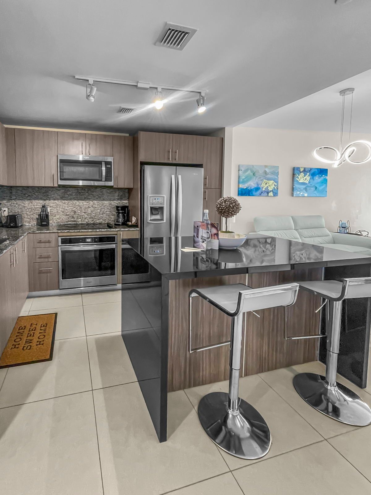 image Cook in style in this sleek kitchen, equipped with stainless steel appliances and a spacious layout.