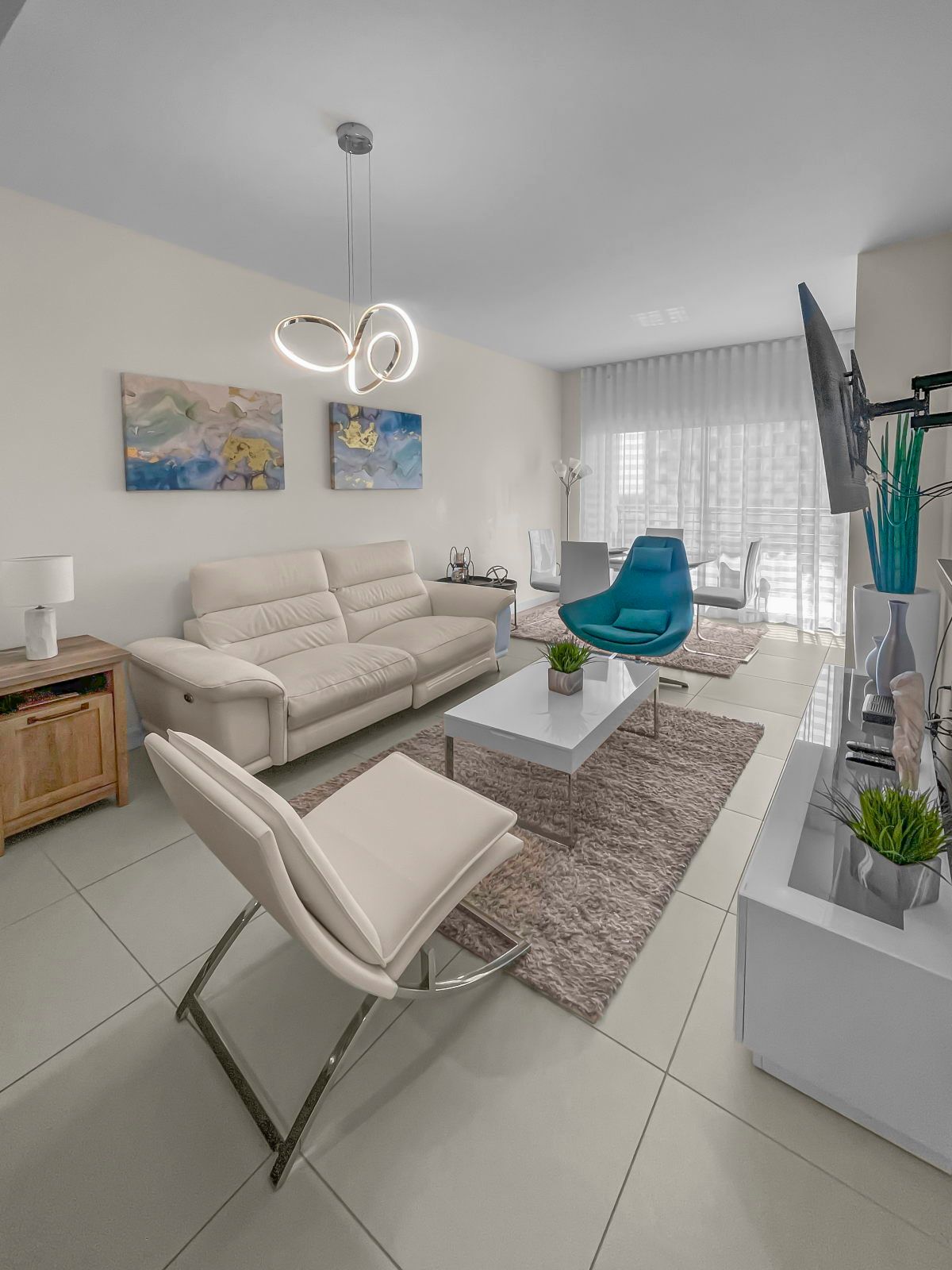 image Unwind in your sophisticated lounge, adorned with contemporary art and cheerful accents.