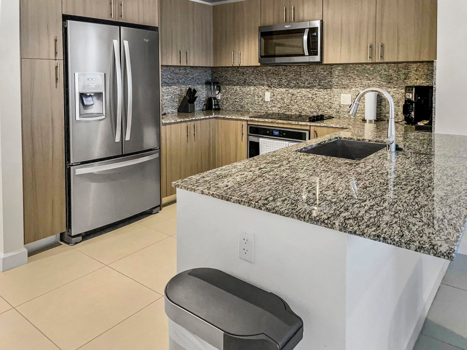 image Cook and entertain in a modern kitchen featuring sleek stainless steel appliances and ample counter space.