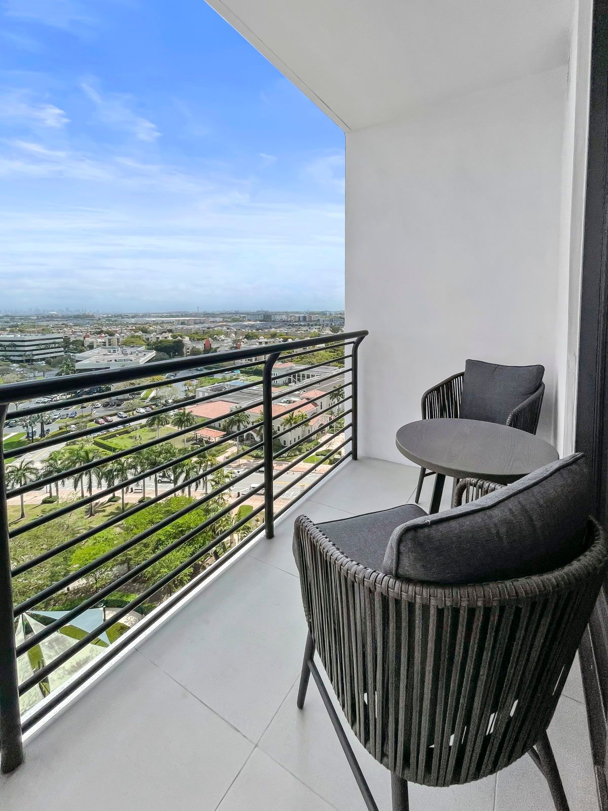 image Enjoy your morning coffee on the private balcony with comfortable seating and city views.