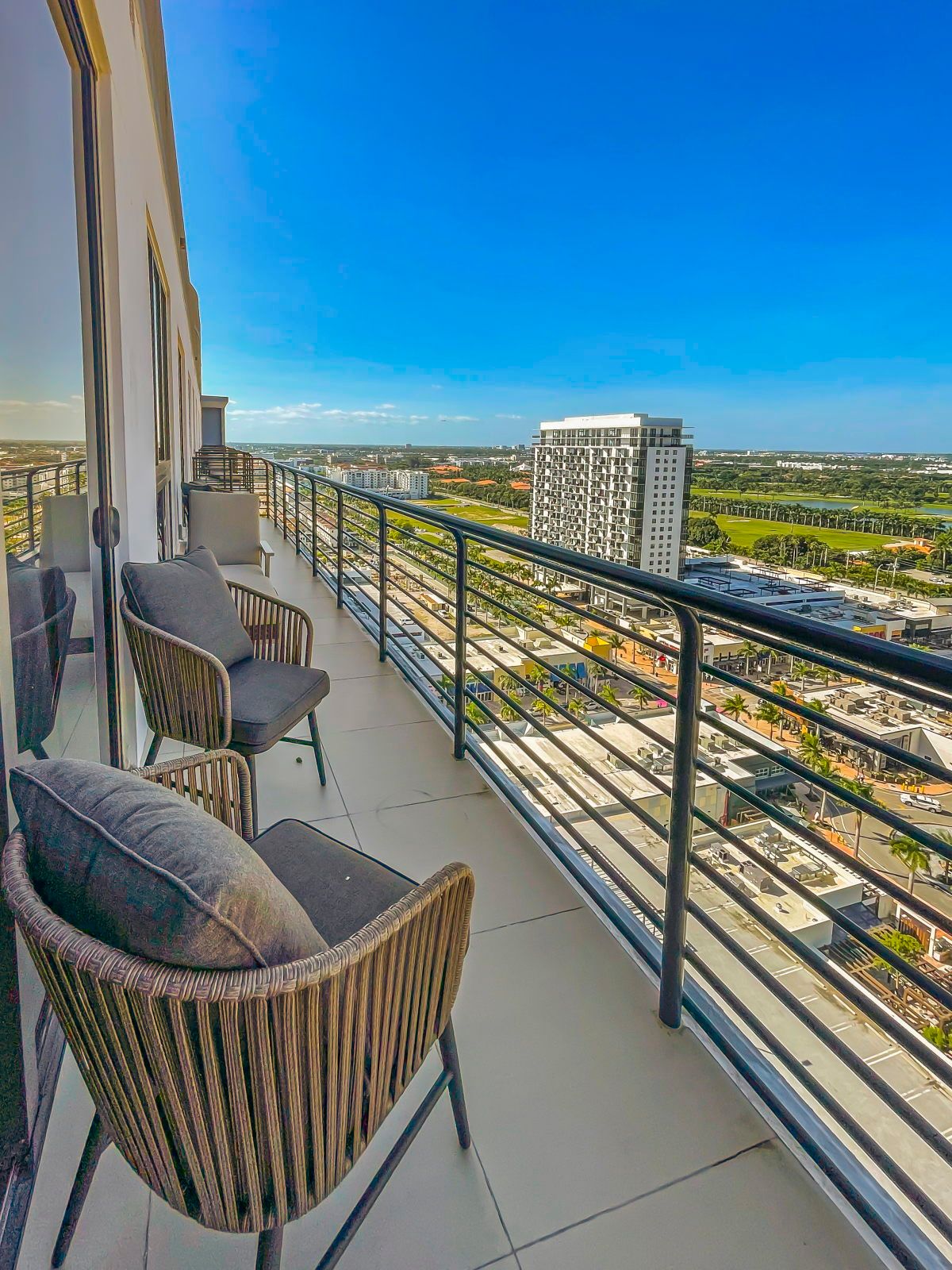 image Relax on the balcony with stylish seating, enjoying the fresh air and uninterrupted blue skies.