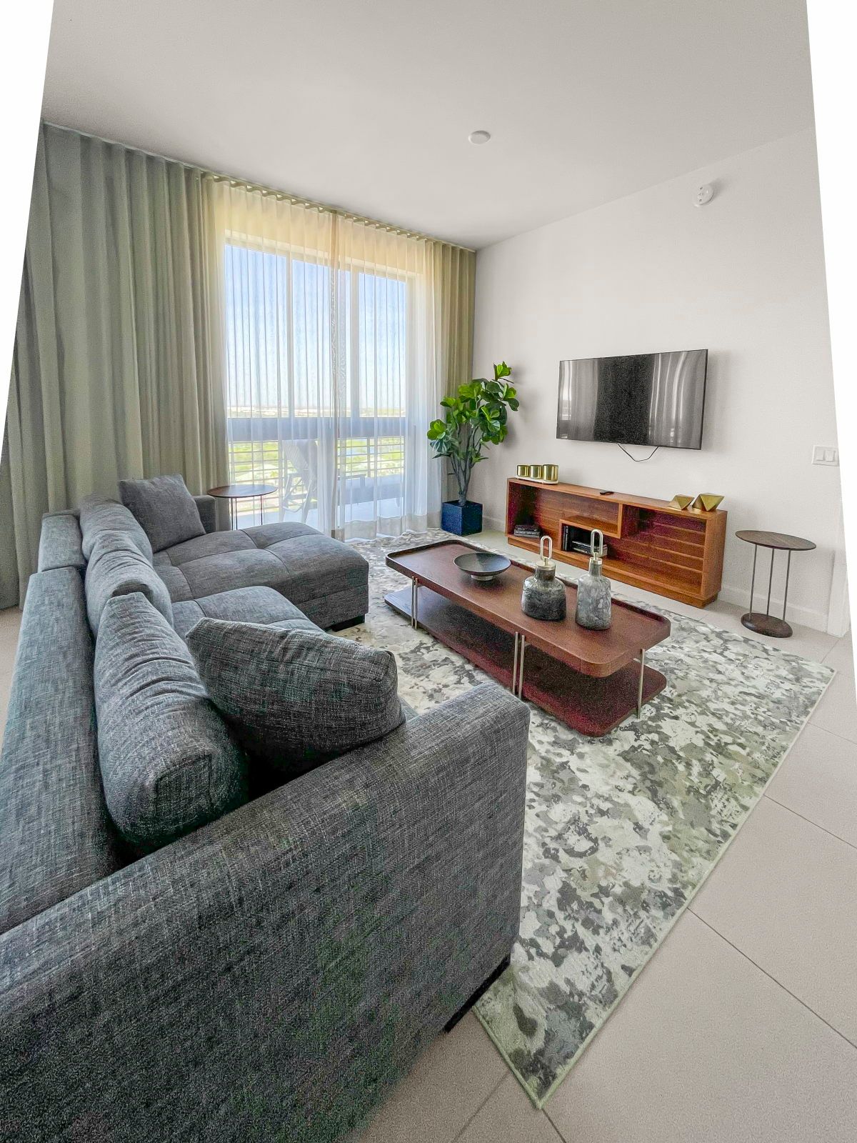 image Unwind in the airy living room, where modern furnishings complement an inviting atmosphere.