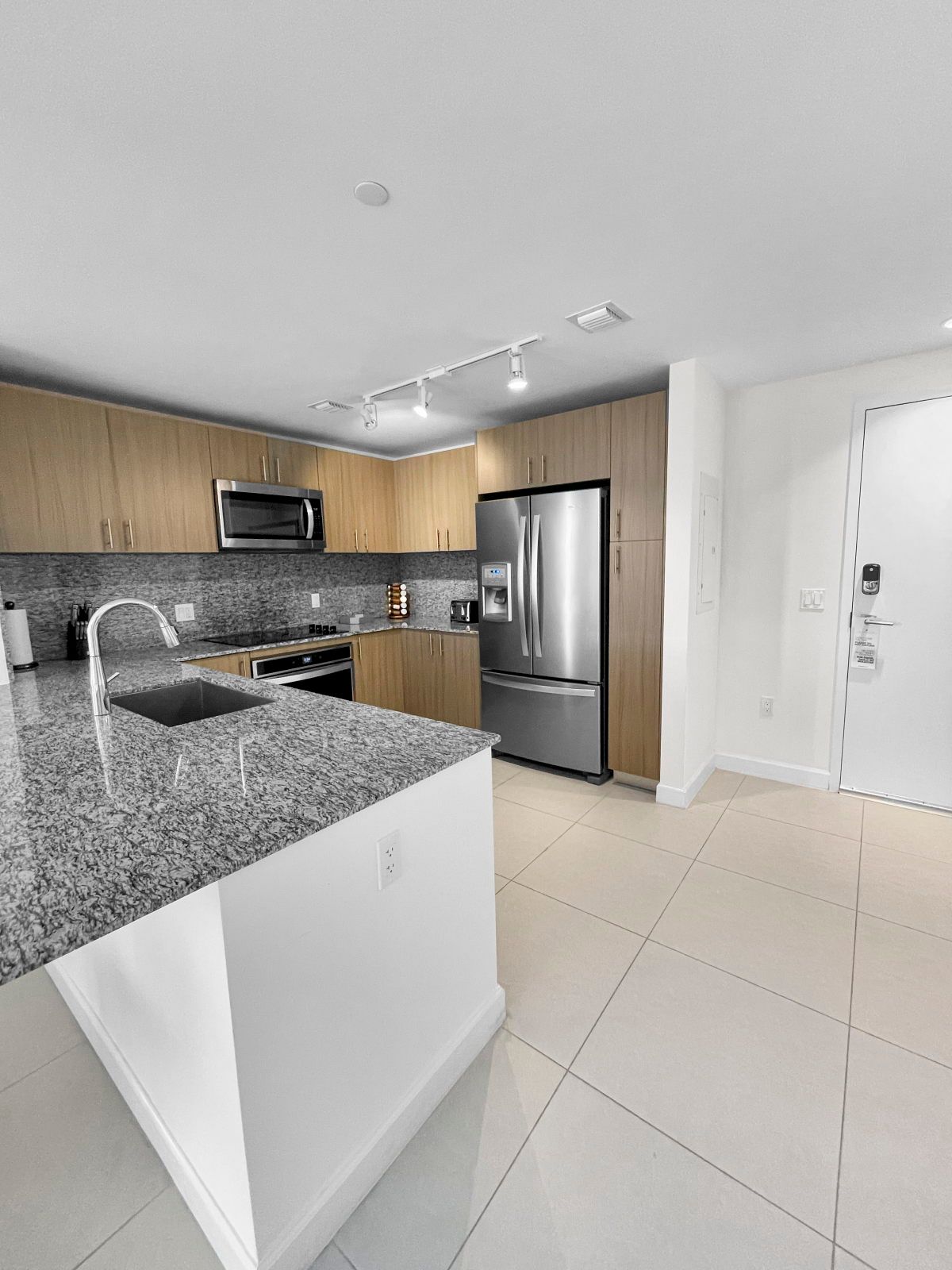 image Cook your favorite meals in this modern kitchen, featuring high-end appliances.