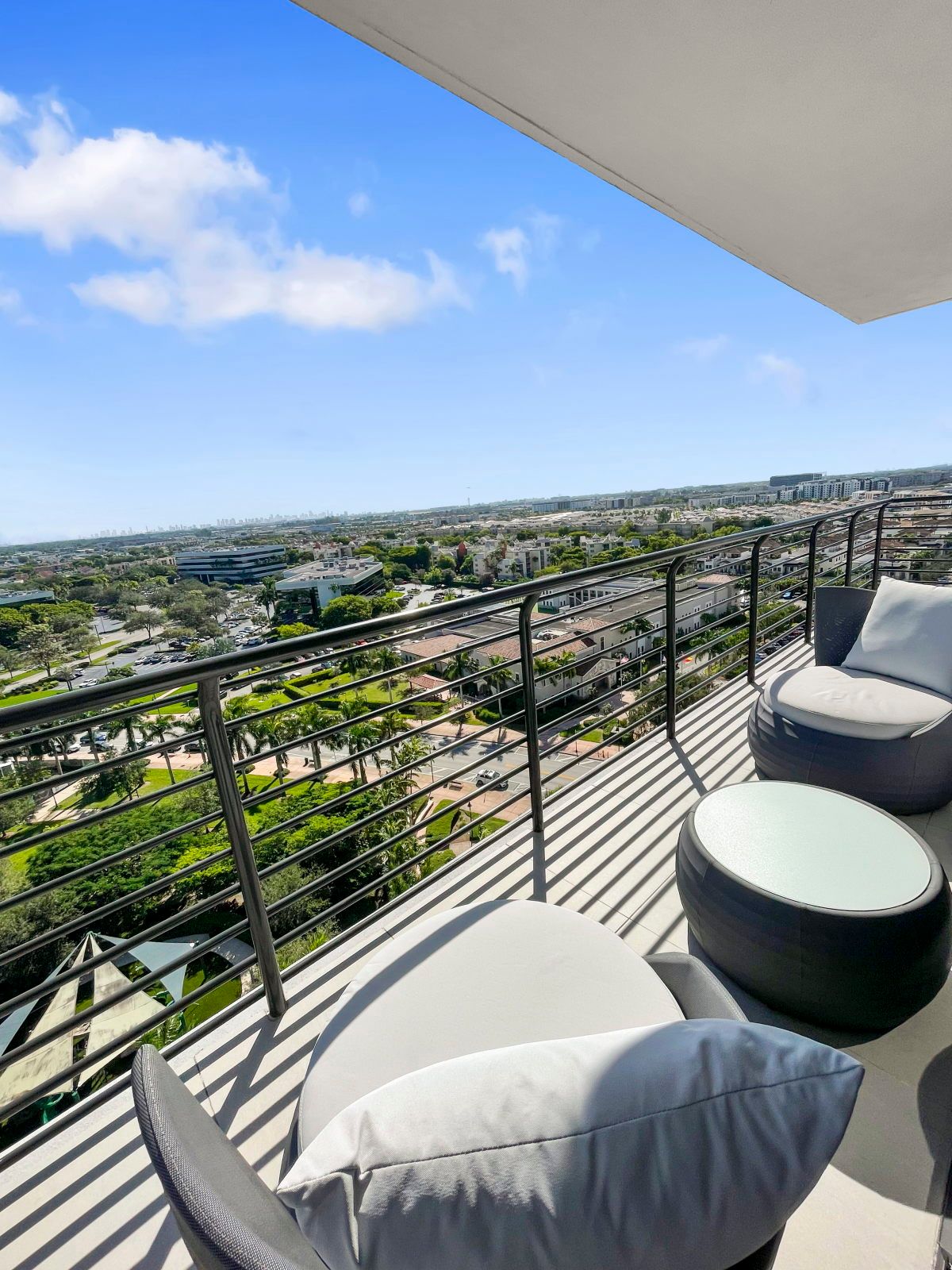 image Savor moments outdoors on the stylish balcony, complete with comfy seating and inviting light.