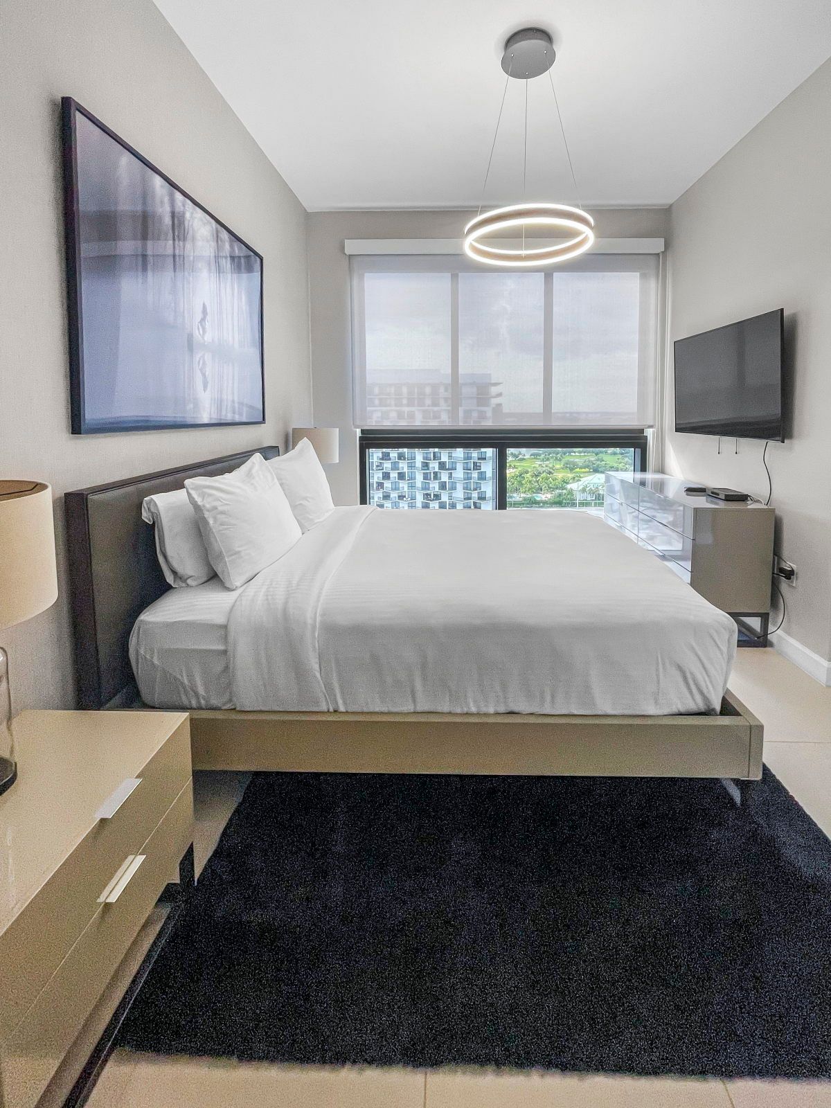 image Rest easy in this stylish bedroom featuring a plush king bed and modern decor with a cozy vibe.