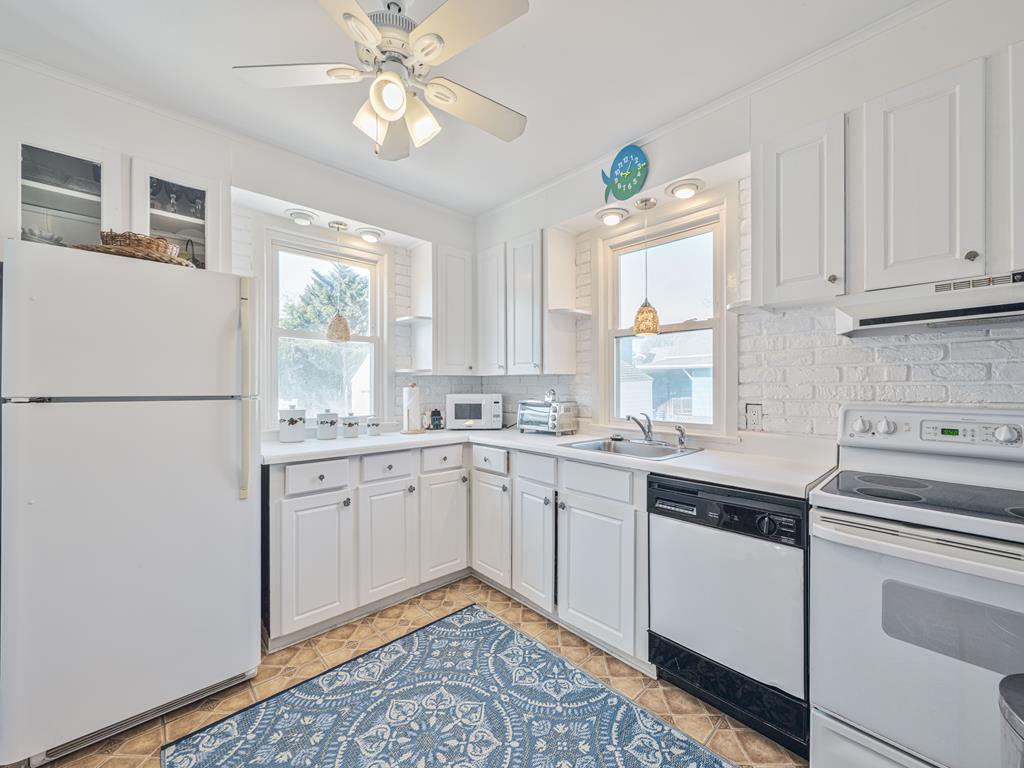 image Cook up your favorite meals in this bright kitchen with ample counter space and inviting windows.