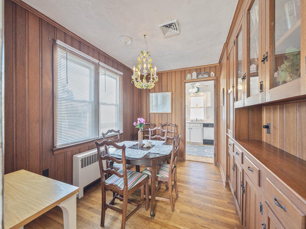 image Gather around the charming dining table, surrounded by warm wood accents and inviting decor.