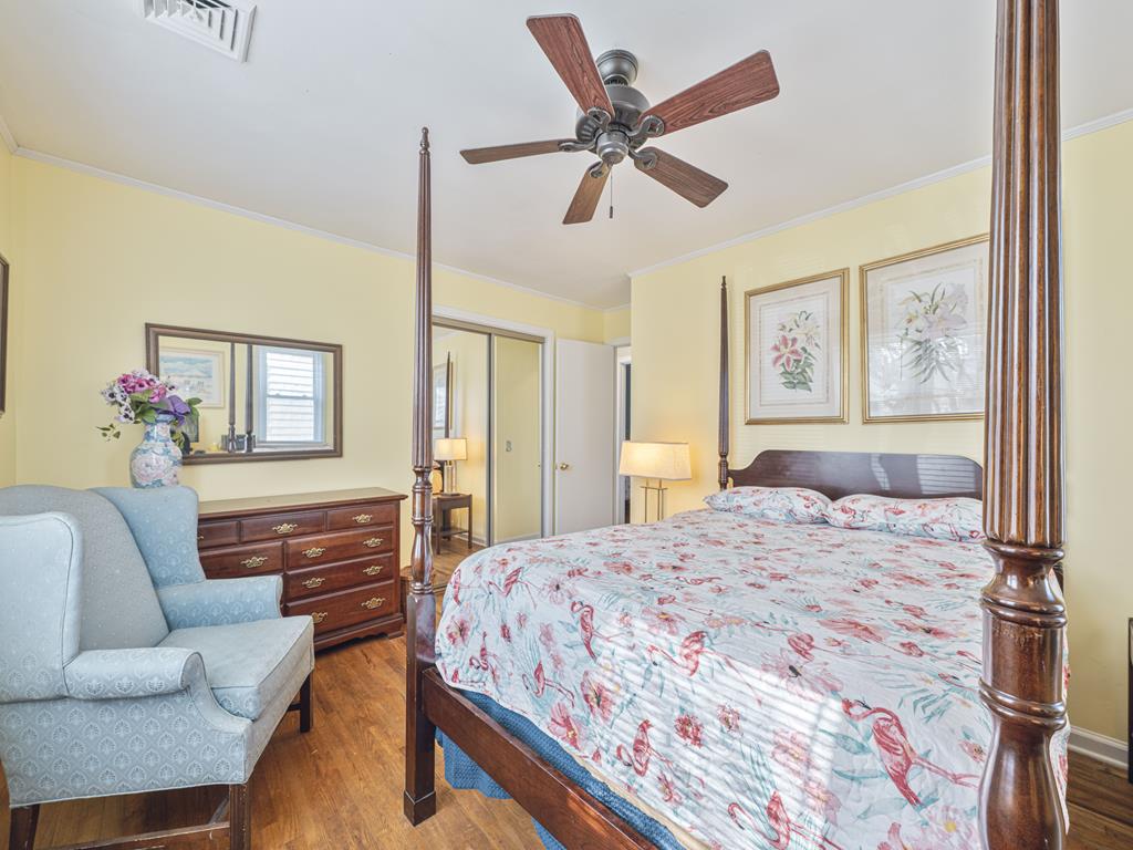 image Unwind in this light-filled bedroom, complete with elegant touches and a comfy sitting area.