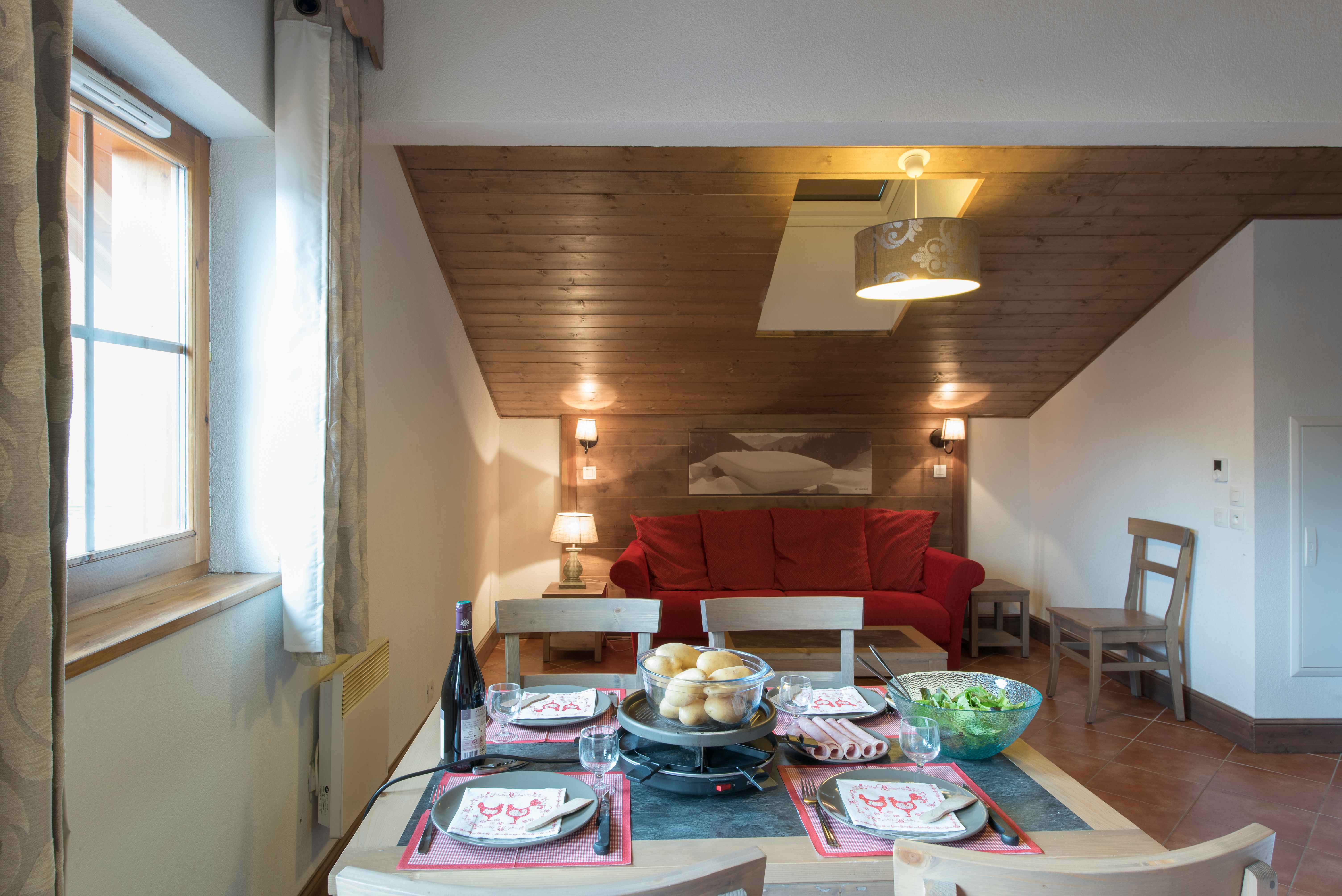 image A bright dining and living area with everything you need — settle in, cook up a Savoyard feast, and make yourself at home in the Alps.