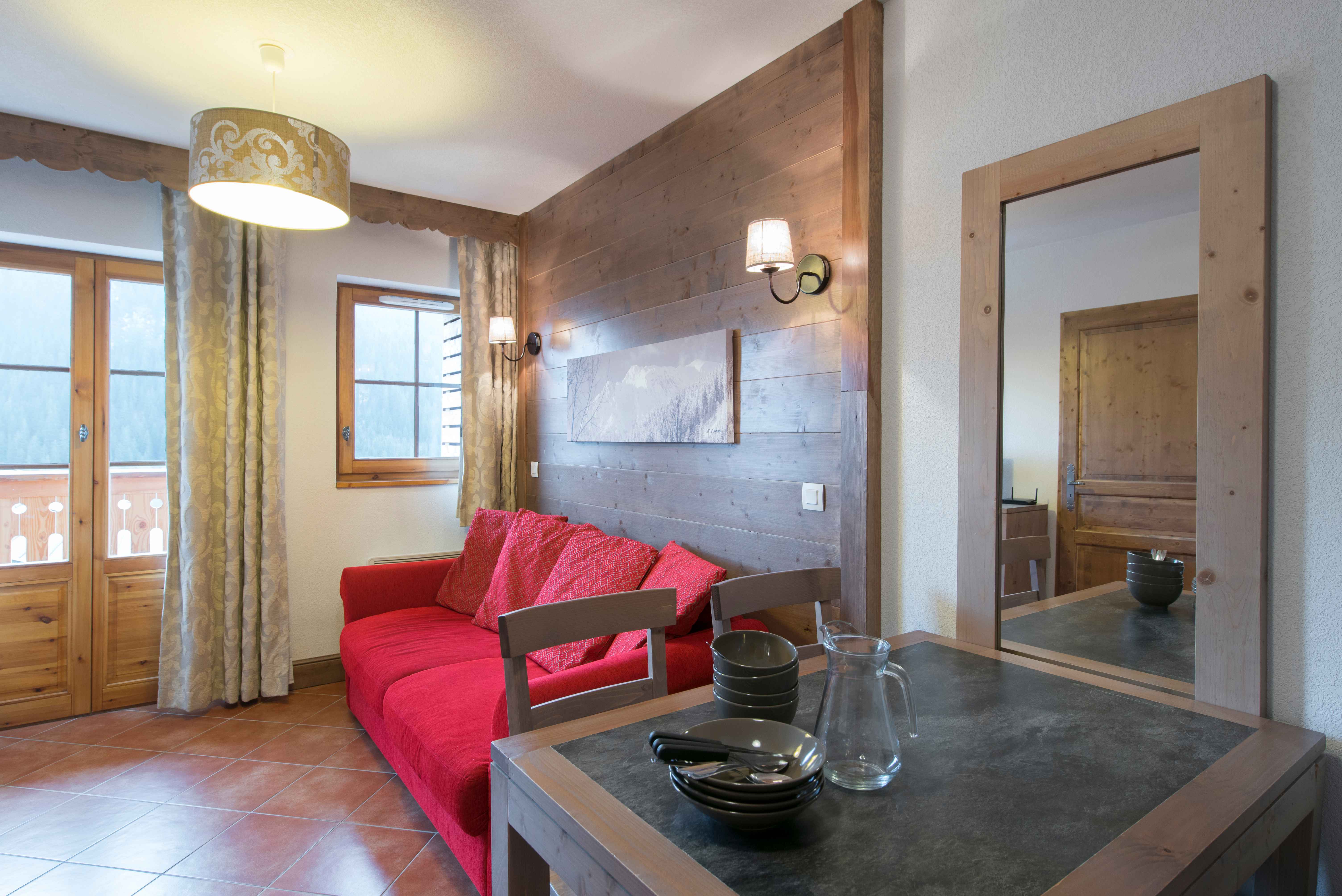 image A spacious living area with sofa bed for two — plenty of room for the whole group to unwind after a day exploring Châtel's pistes or summer hiking trails.