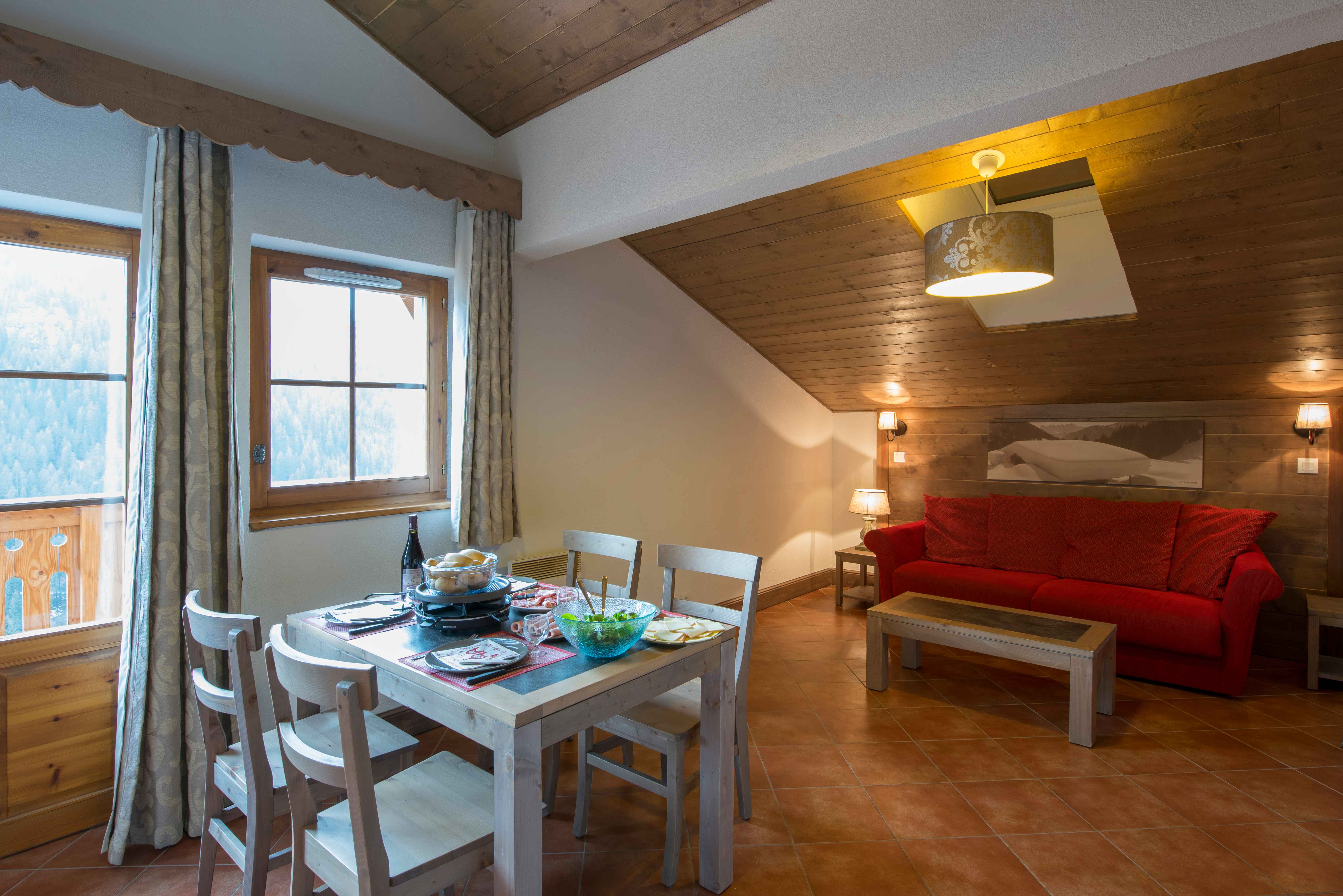 image A generous open-plan living and dining area with sofa bed — flexible space for larger groups to gather, relax, and share stories from the pistes or trails.