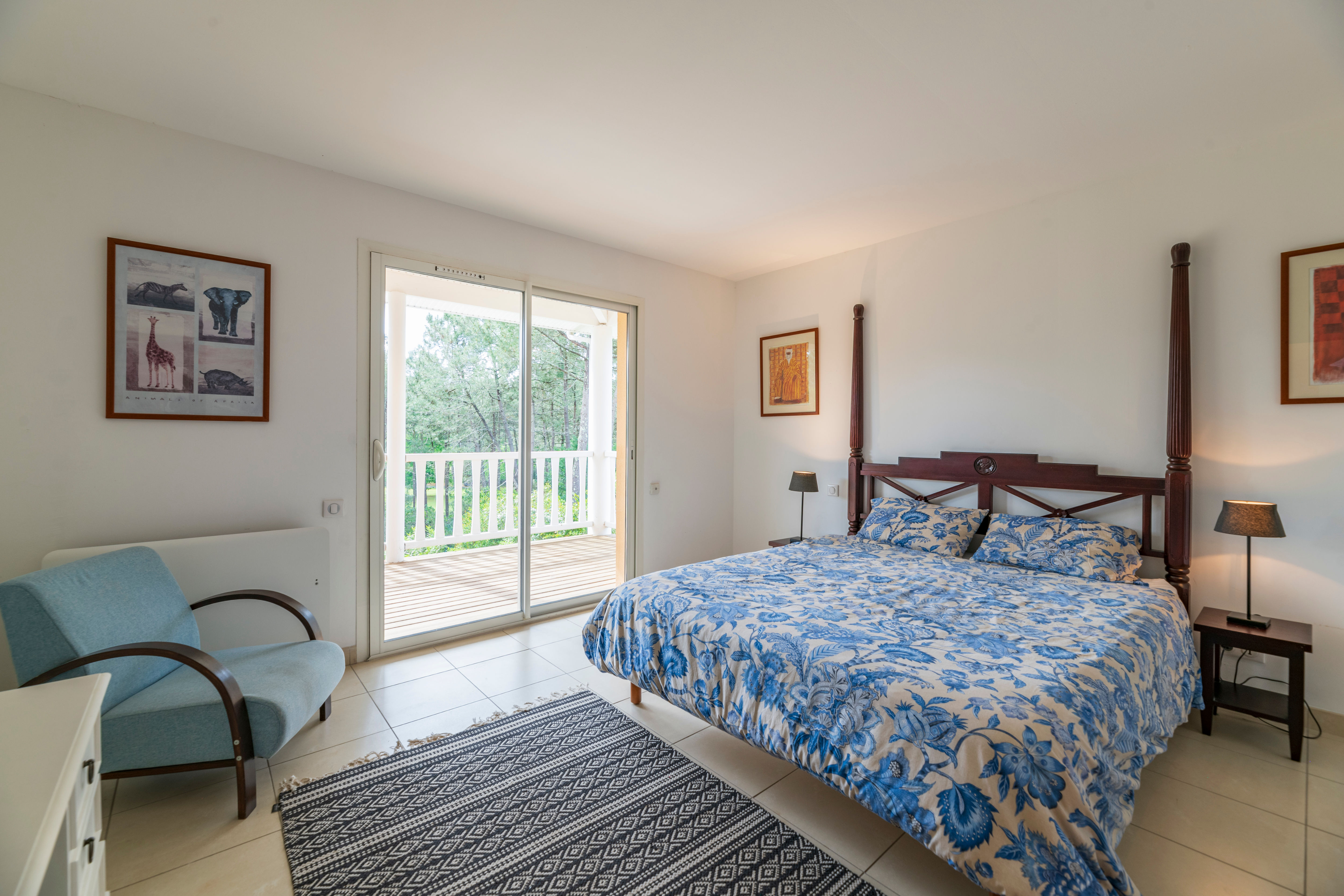 image Relax in this tranquil bedroom featuring a cozy double bed and a charming view from the balcony.