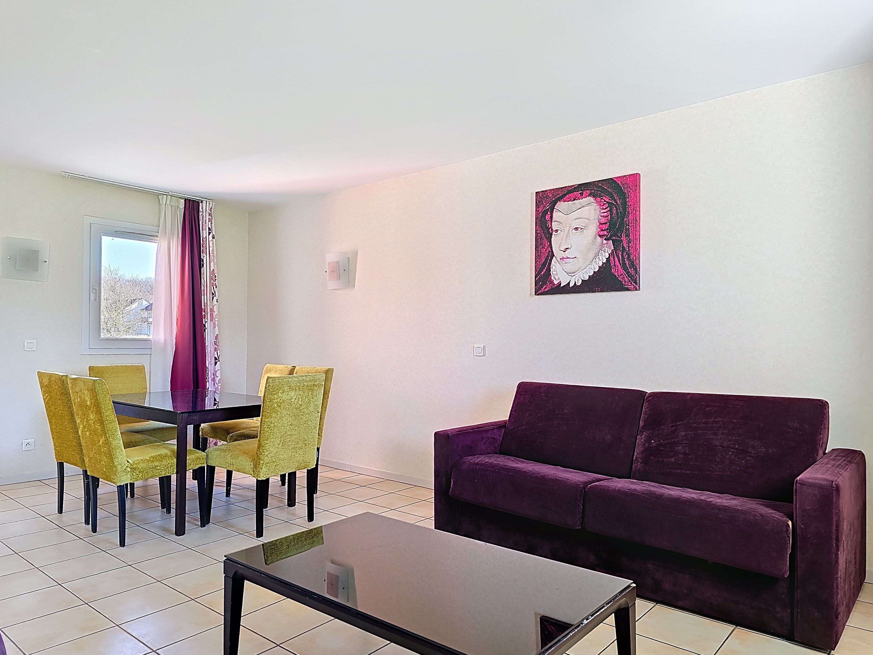 image Dining space with a purple sofa, glass table, and yellow chairs — seats the whole group on the ground floor
