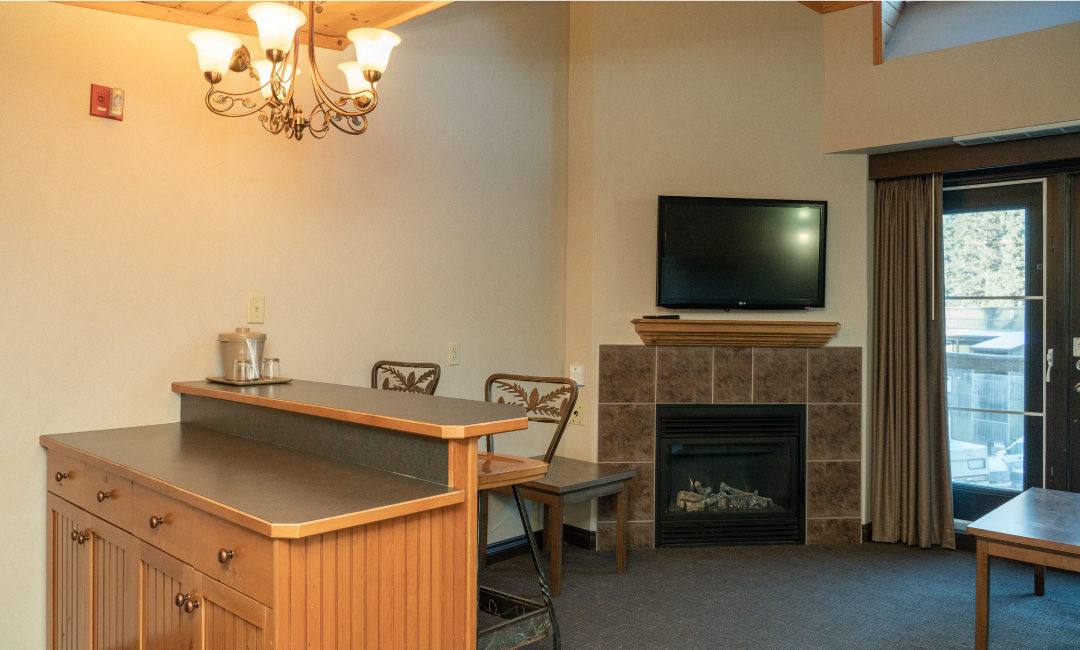 image Living area with gas fireplace and TV.