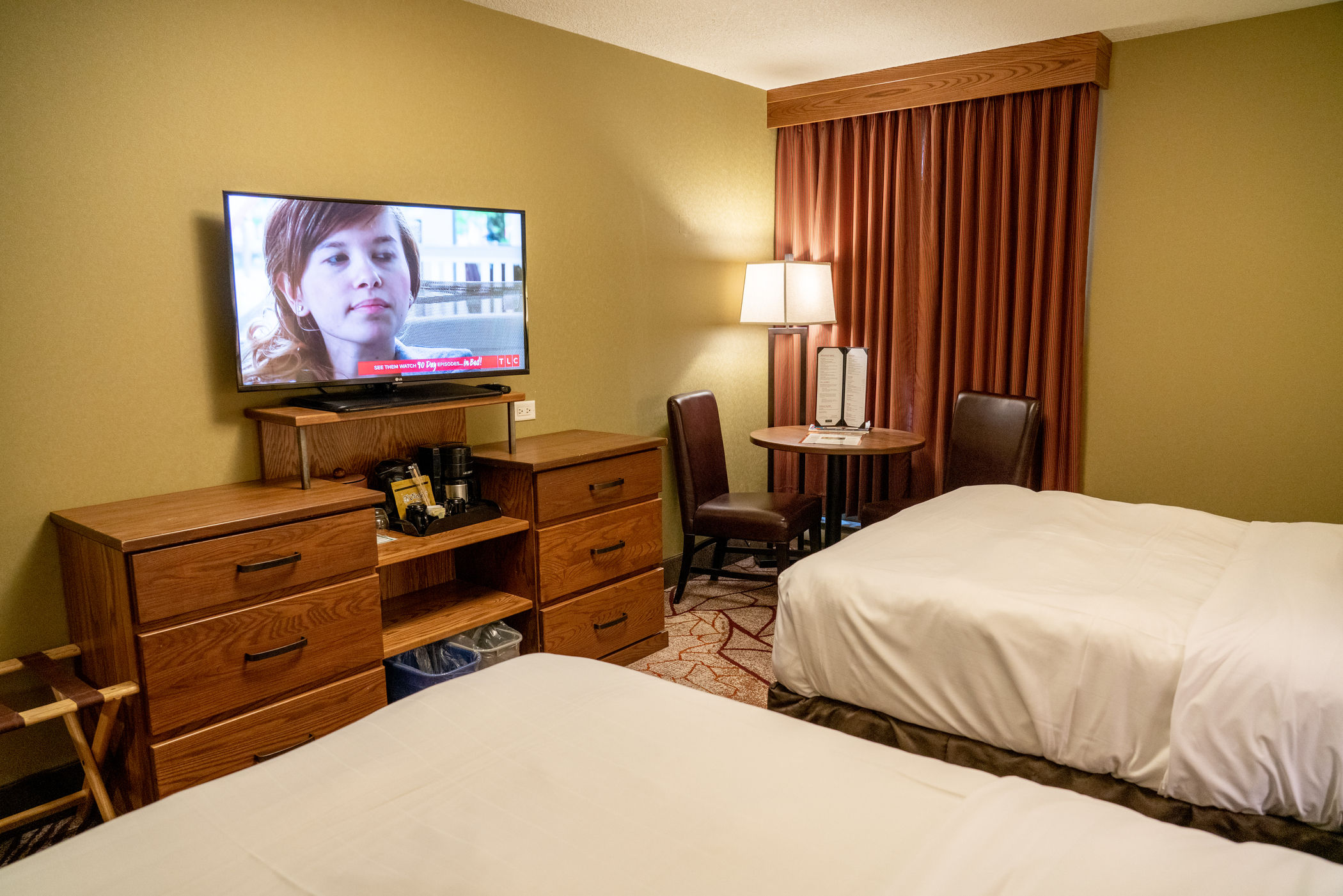 image Flatscreen TV and mini fridge set up for downtime — drip coffee maker ready for your morning before heading out.