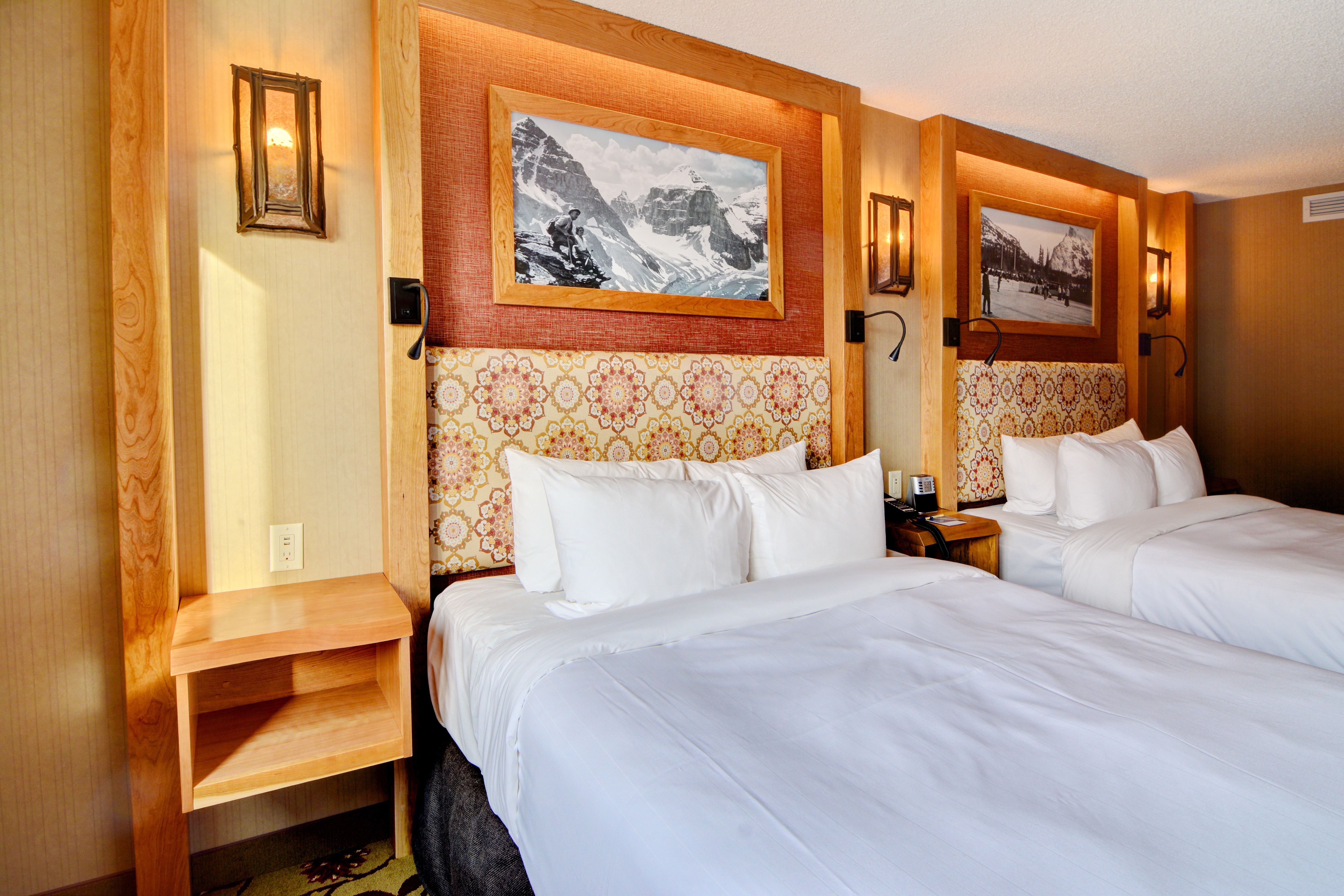 image Two Queen Mountain Luxury beds with matching headboards and a flat-screen TV — room for the whole family after a day on the slopes